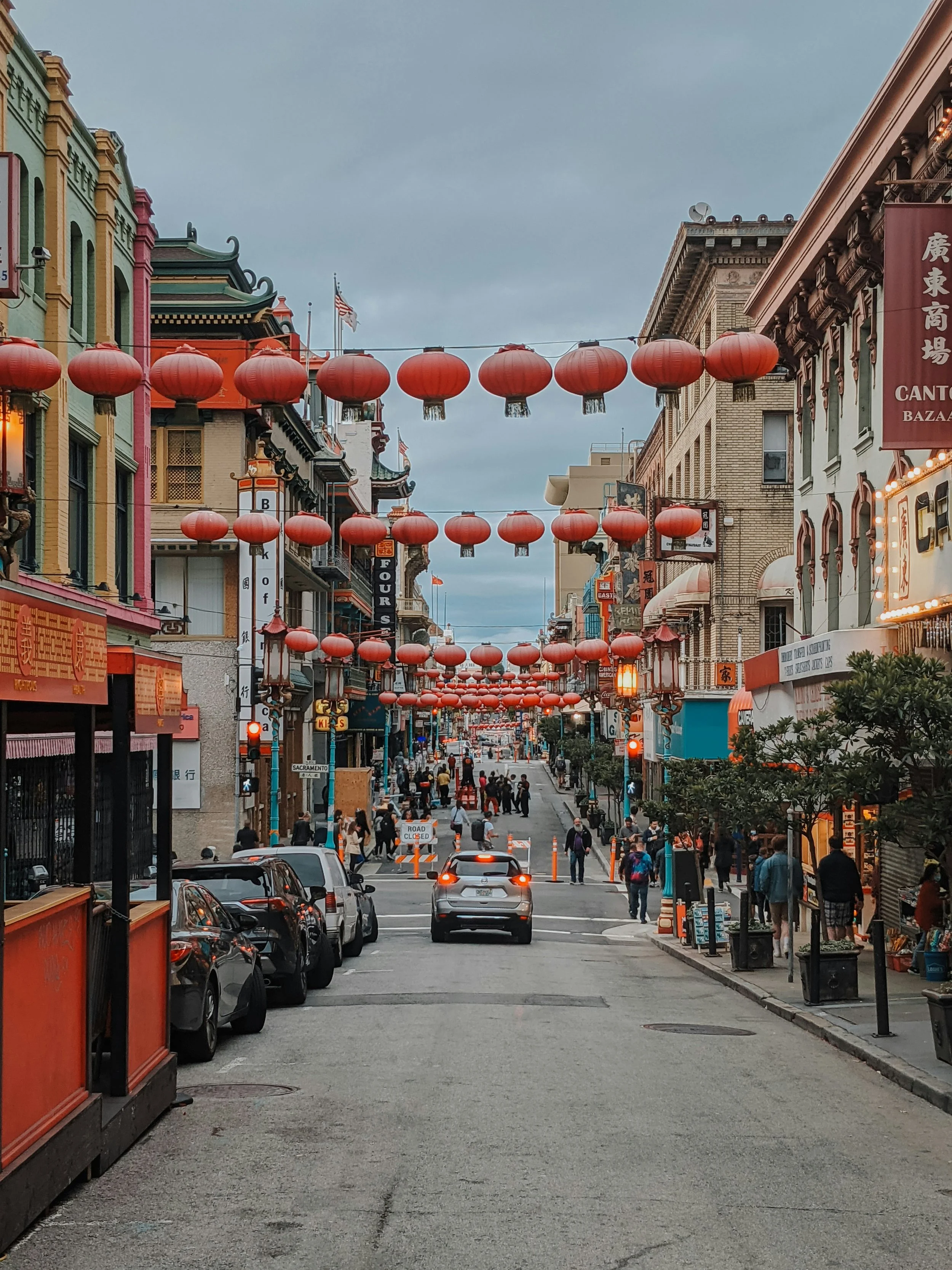 Orange lanterns hang across a street in San Francisco Chinatown