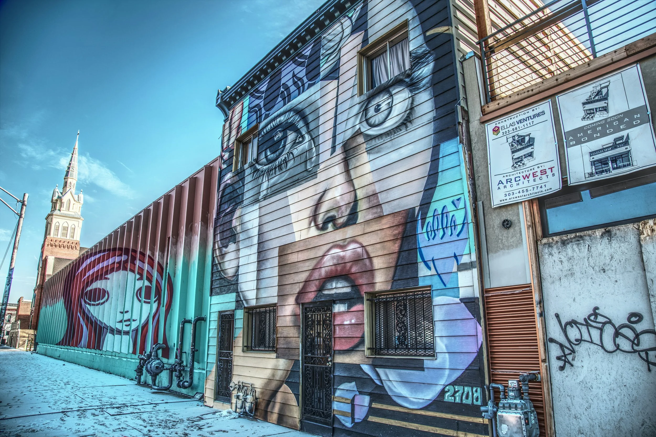 A large piece of street art in Denver Lower Downtown shows a collage of a woman crying
