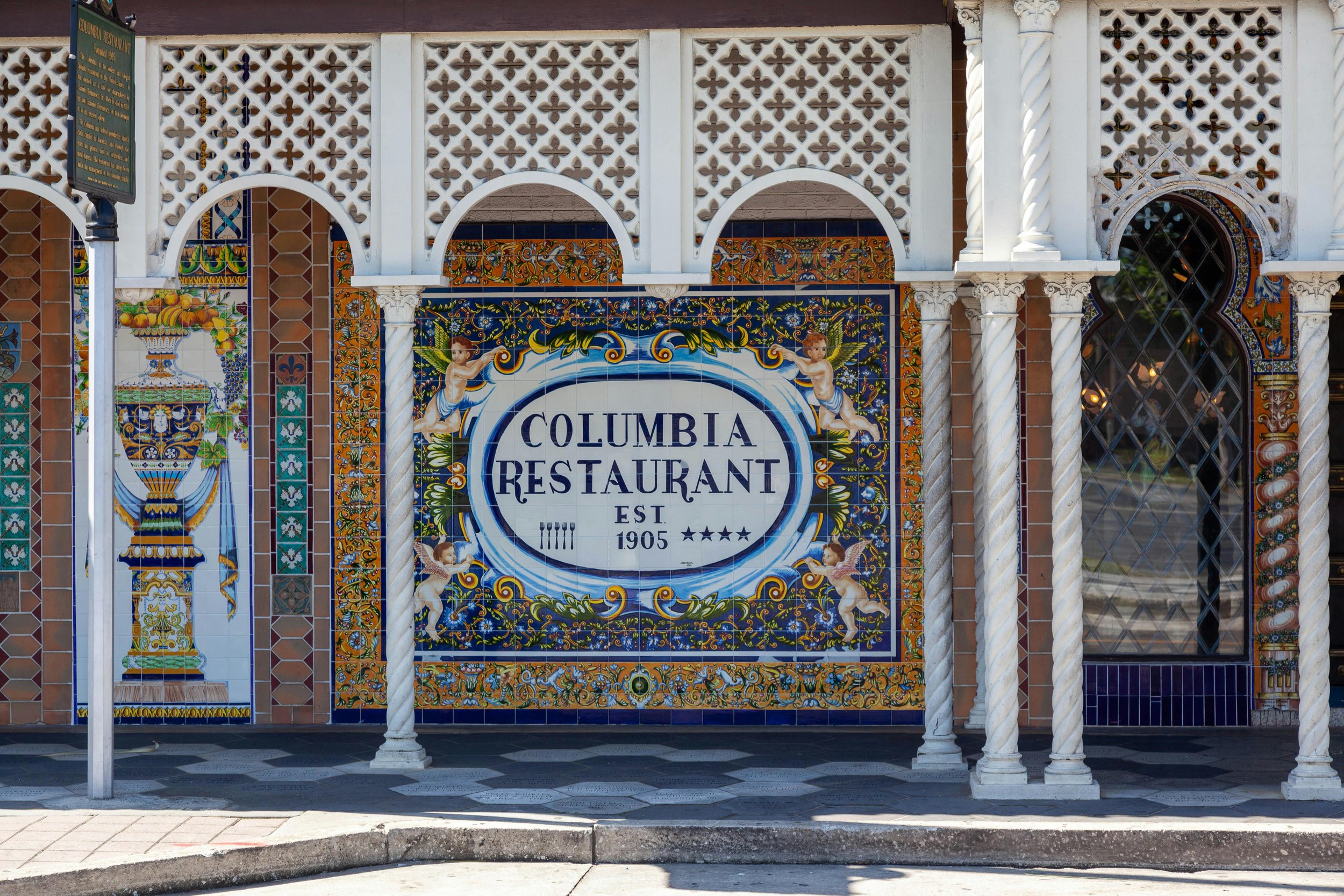 The famous Columbia Restaurant in Ybor City, Tampa. Spanish tiles cover the wall, showing flowers, cherubs and the name of the restaurant