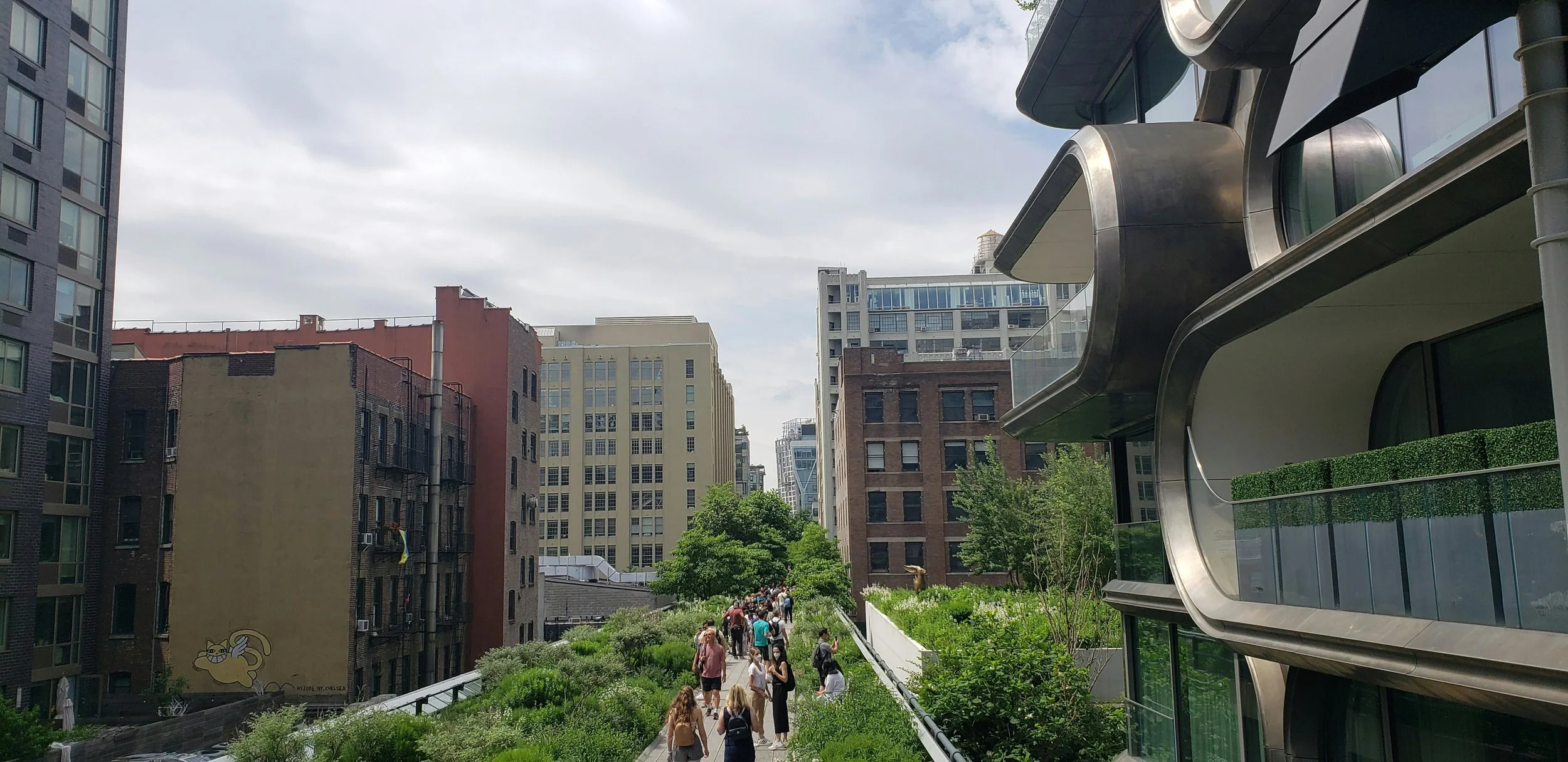 People walk through the architecture that surrounds the High Line, New York. Drives & Detours New York High Line walking tour