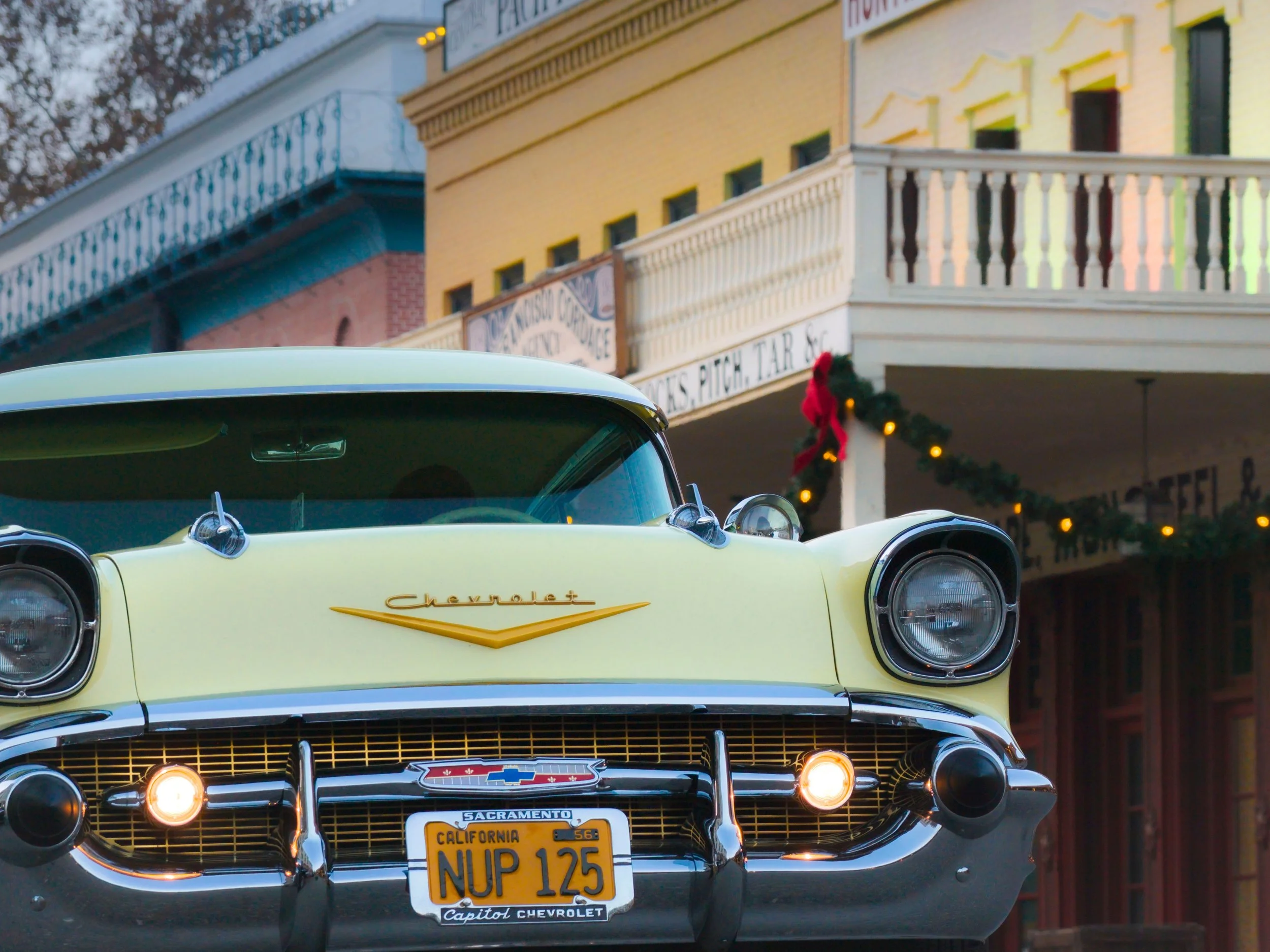 A classic yellow Chevrolet sits in a wild wild west town, with California plates. Drives & Detours  Sacramento attractions for families