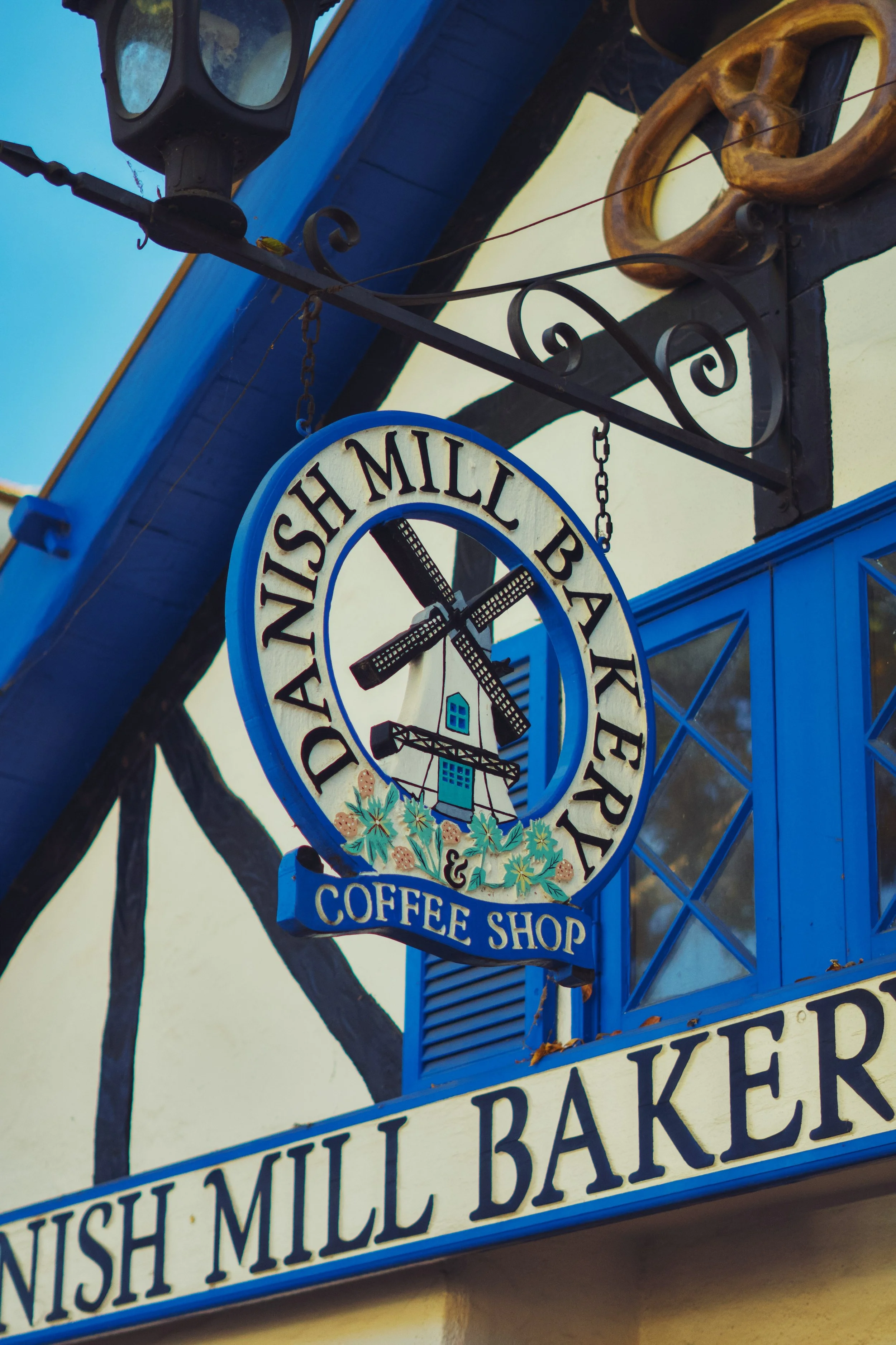 A sign for the Danish Mill Bakery and Coffee Shop in Solvang, California.
