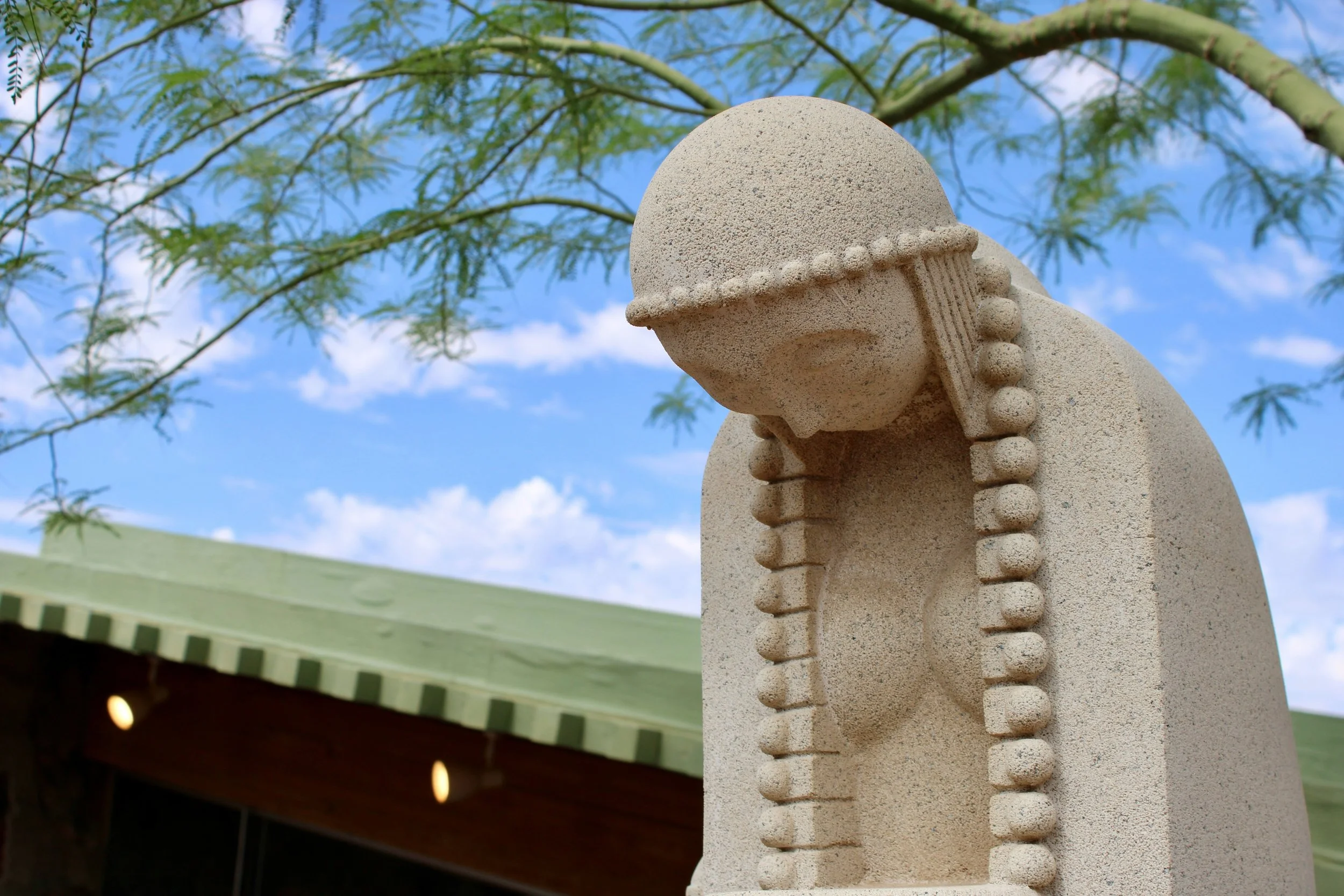 A stone statue of a woman looking down in Scottsdale, Arizona