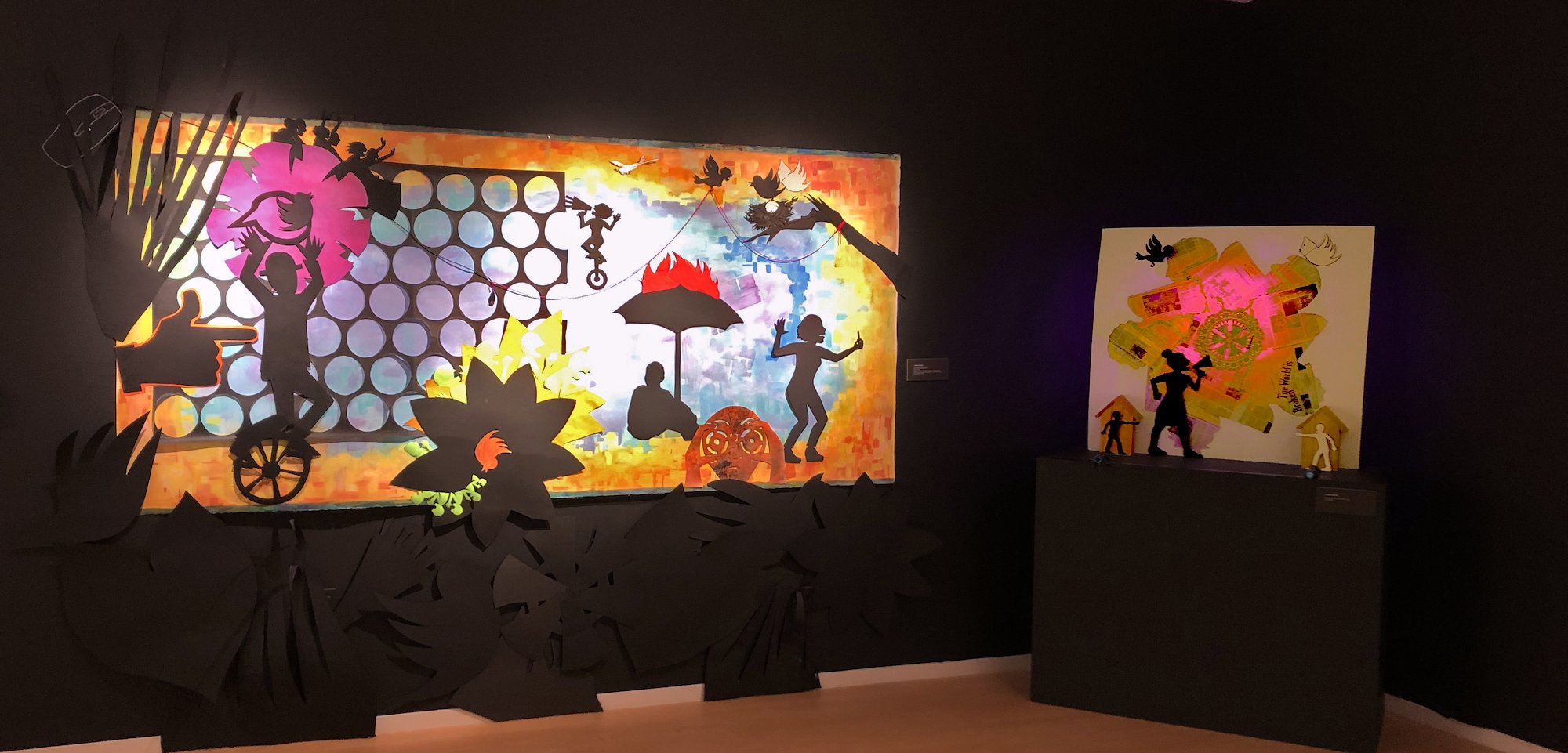 Combustible Landscape" and "Broken World Calls for Action" corner