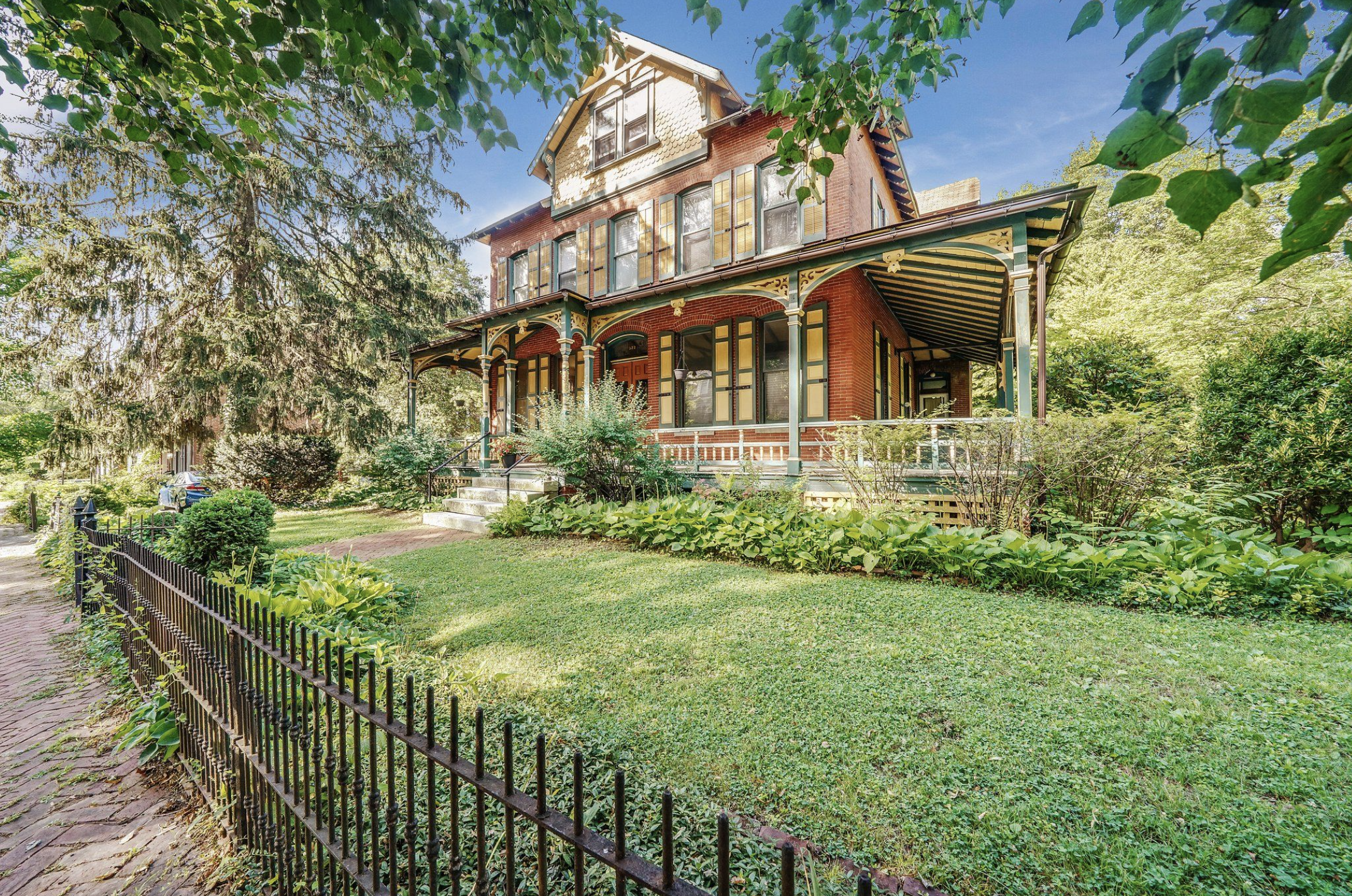  The property was built in 1887 and boasts a large wraparound porch, tall ceilings, and traditional architectural details 