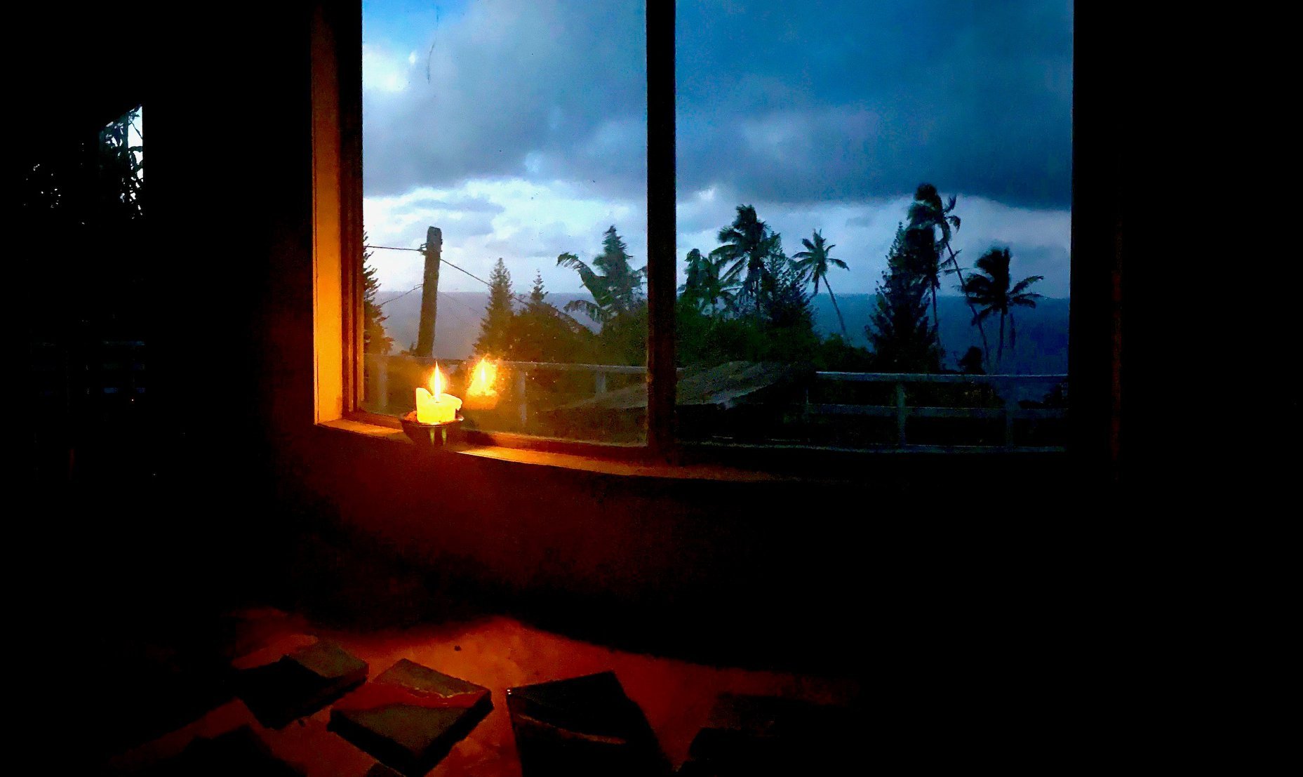 Pitcairn's Deputy Mayor, Kevin Young, frames a Candle in the Window for the world's empty horizons and the craft work he's put aside as Pitcairn manages its Covid-19 border controls. 
