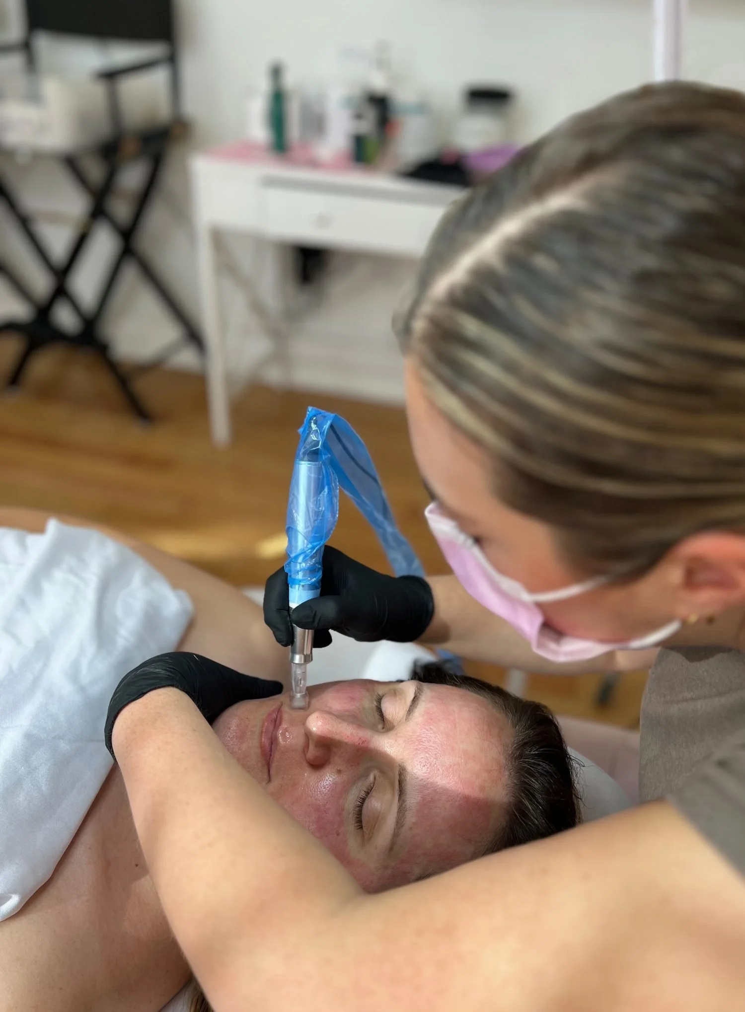 Malia performing a microneedling treatment at All That Beauty Bar in Ottawa