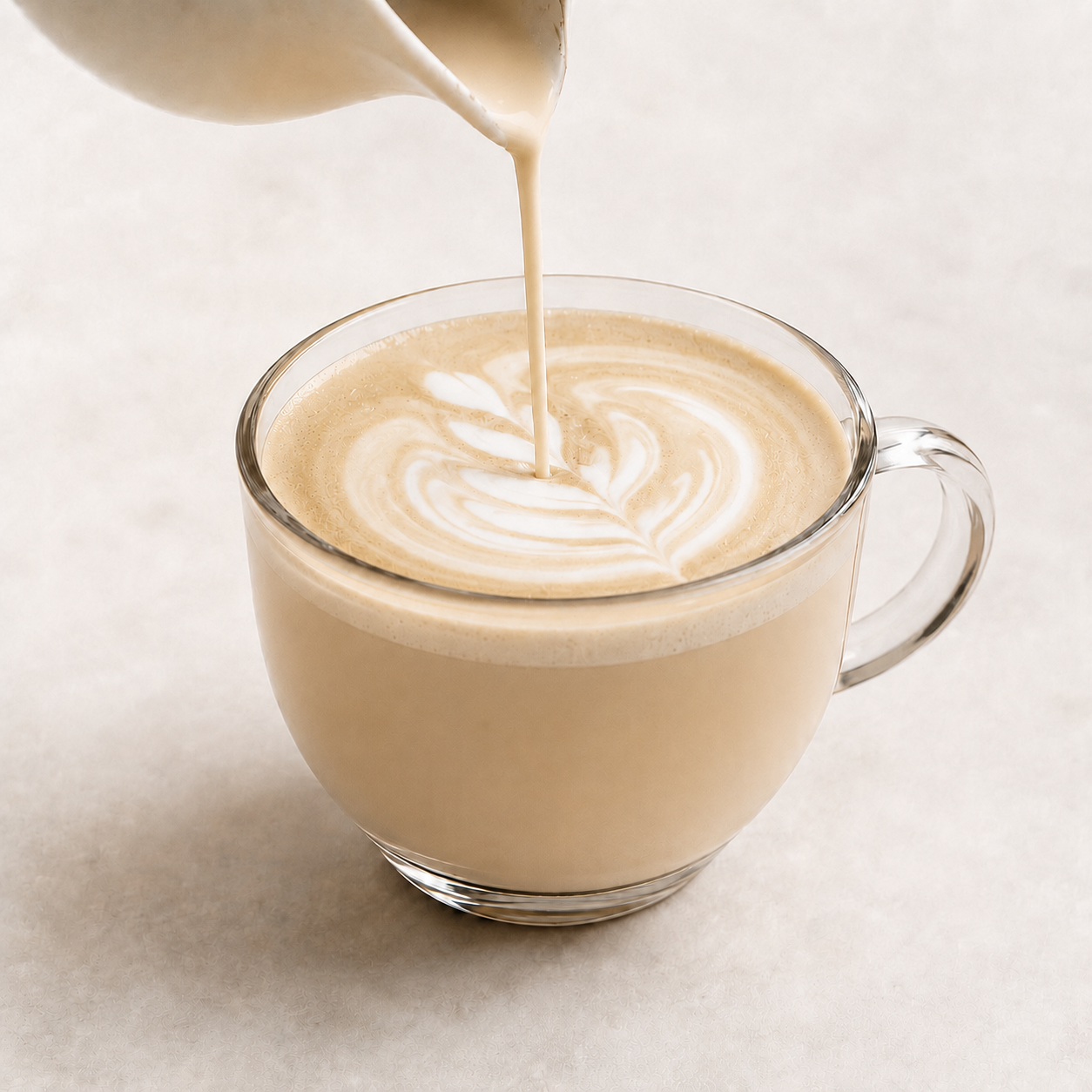 Vör Cashew Nut Milk Base poured into a hot latte with creamy foam and latte art.