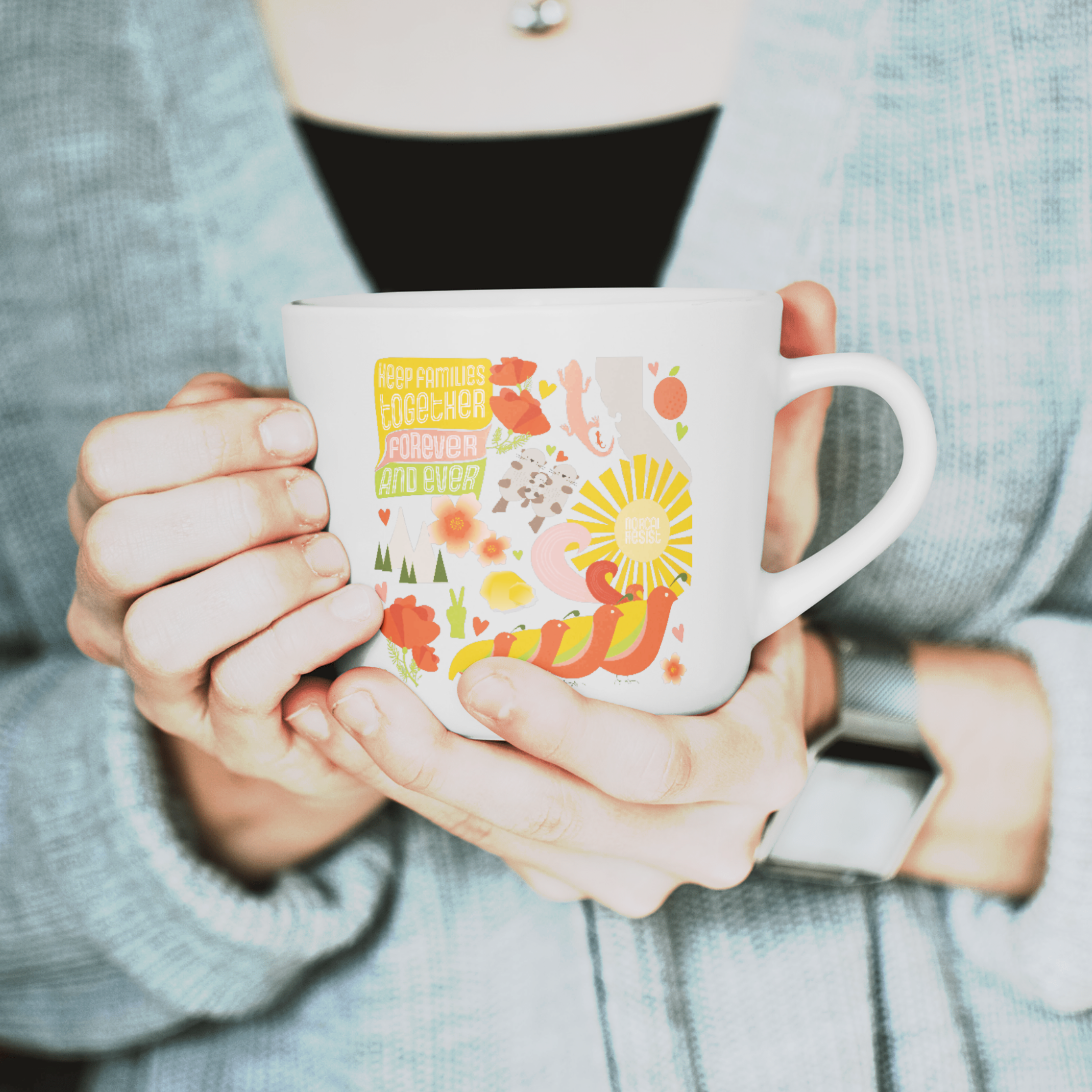 Woman holding a white cup with a colorful illustration