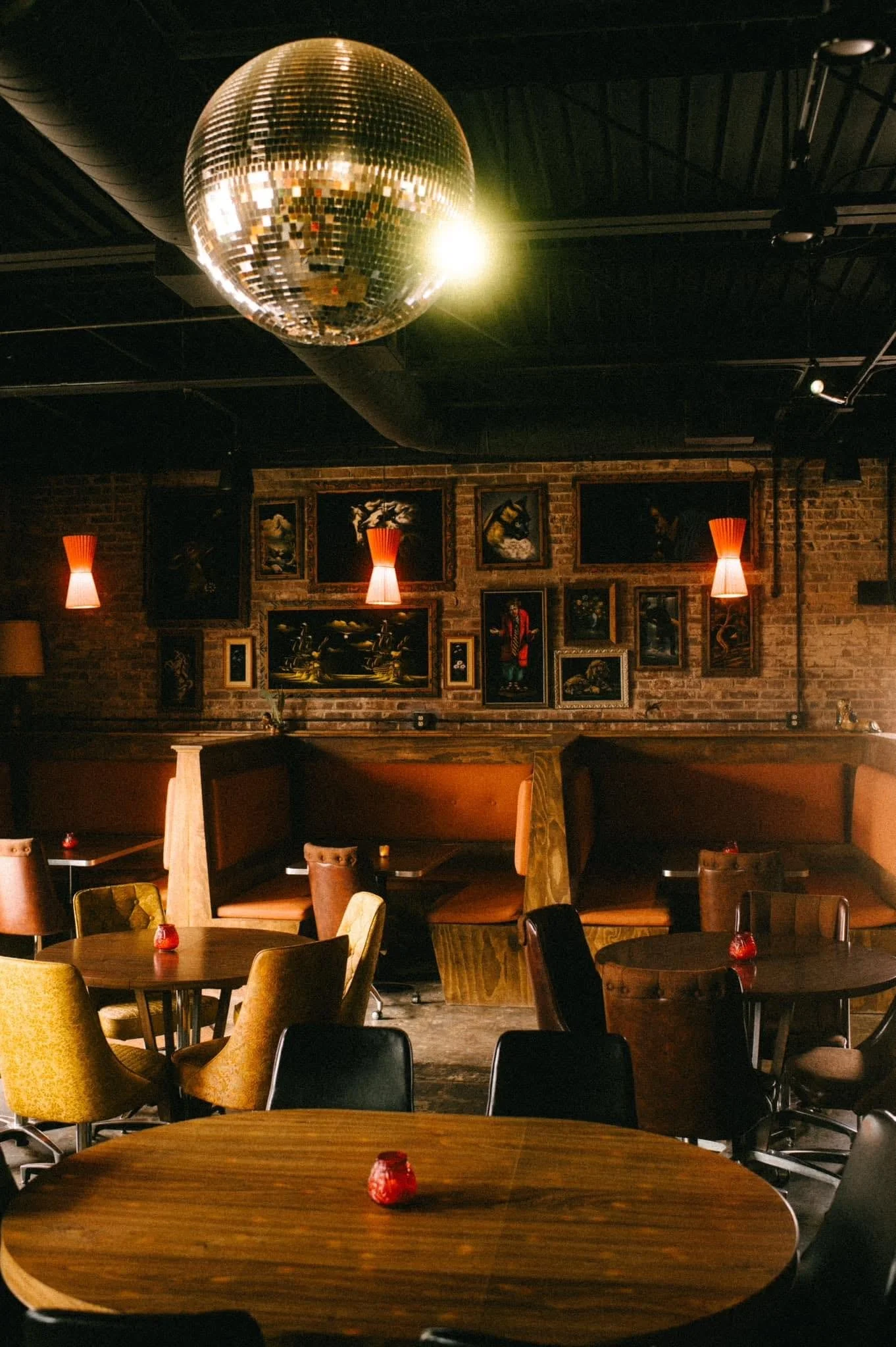 The warm, vintage-inspired interior of Fly by Night, a playful Sevier Avenue cocktail bar.