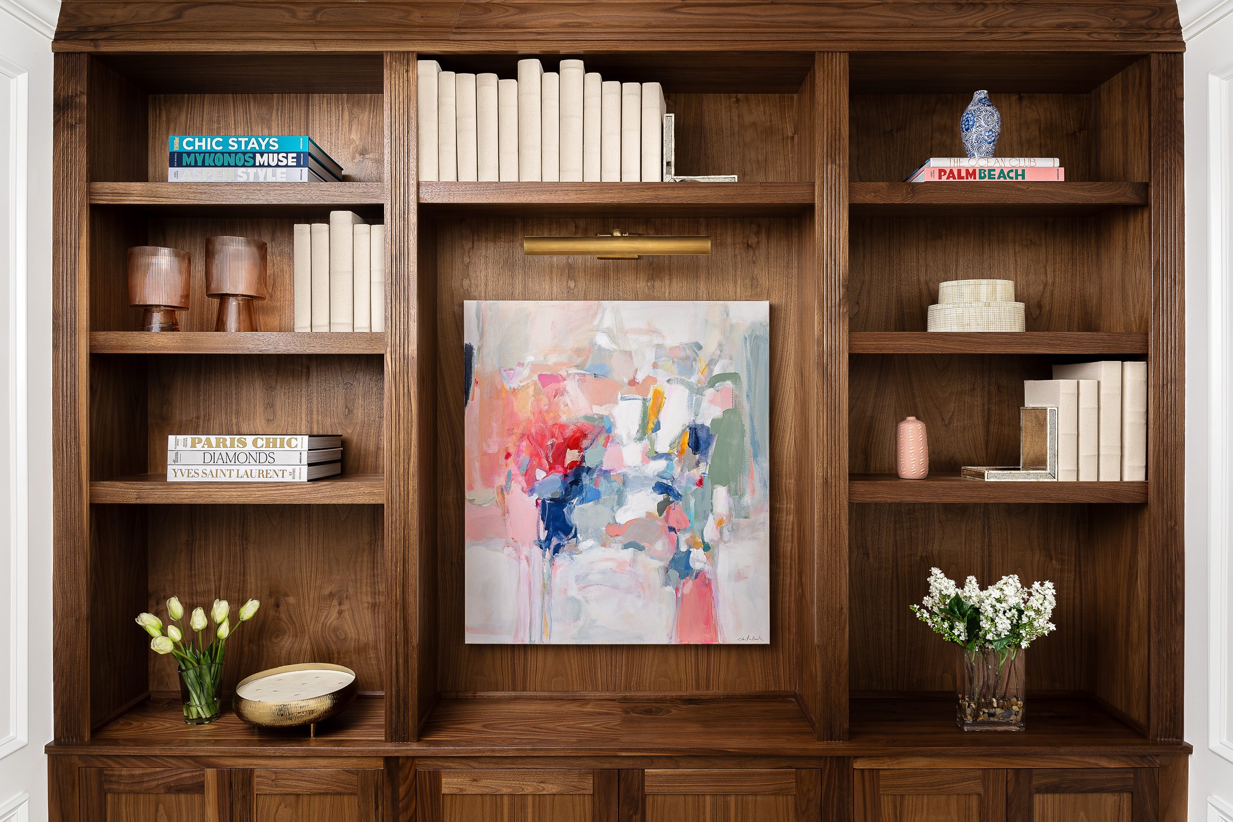 A sophisticated, feminine home office with original Christina Baker artwork, brass hardware and lighting, and high-end decor.