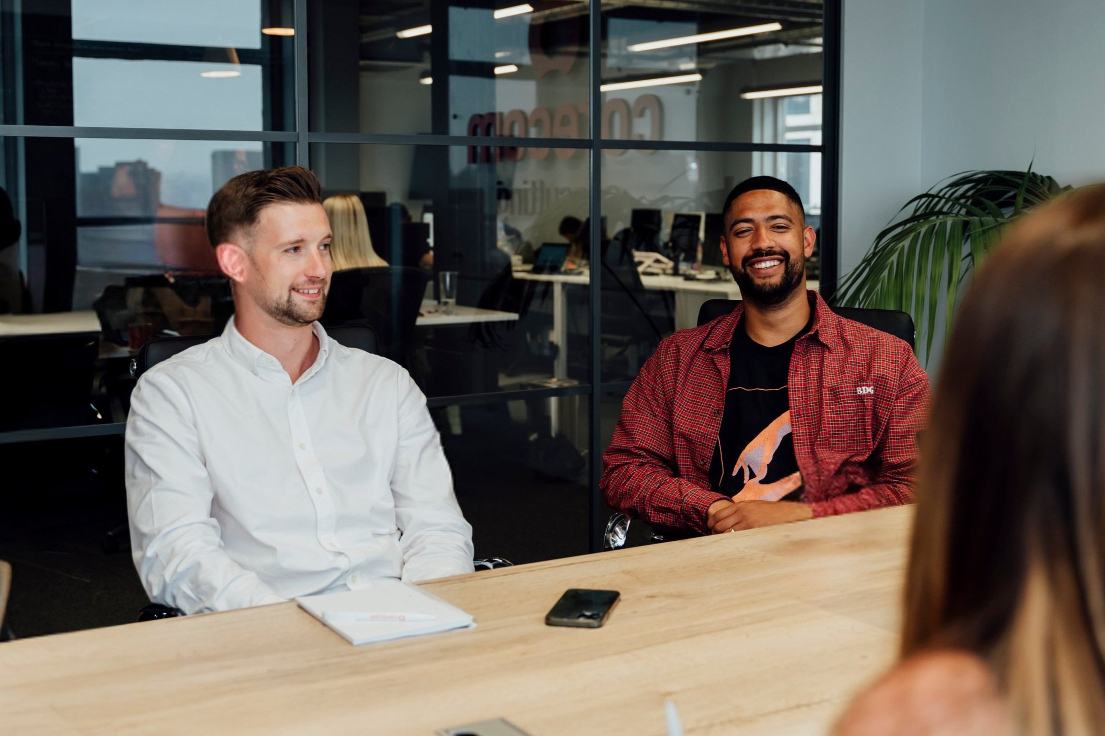 A group of Corecom Technology staff in a boardroom