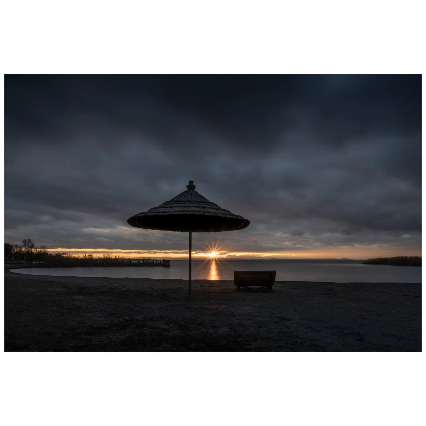 Down here at the Neusiedlersee, November has its own kind of beauty. When the tourists leave and the Burgenland winds pick up, these beach umbrellas stand like silent sentinels. The light finds its way through even the heaviest clouds, just as it alw