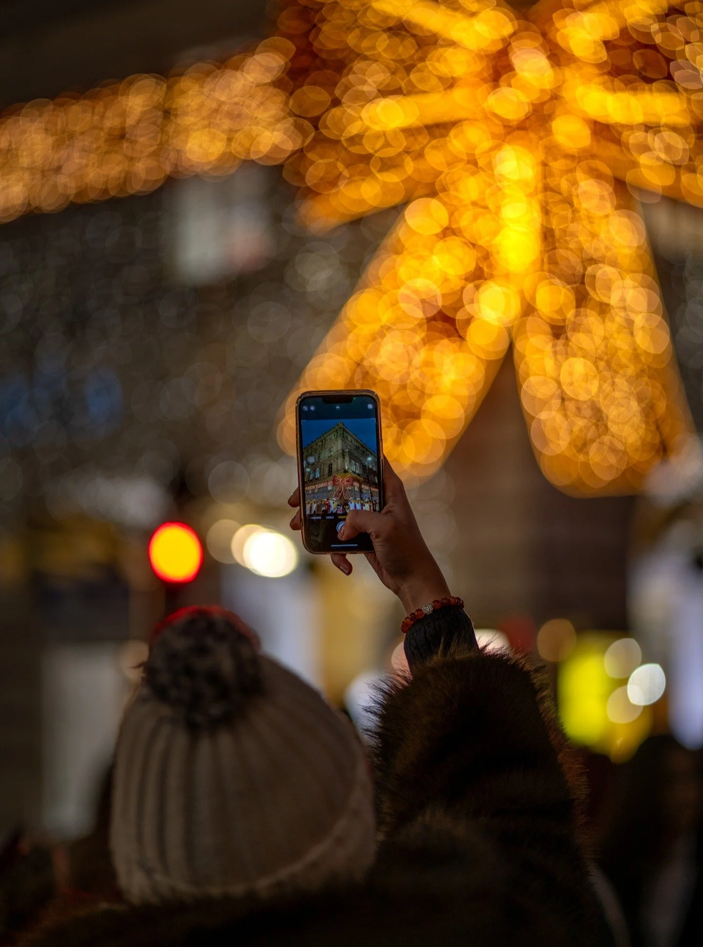 Some moments exist twice, once in the viewfinder and once in the heart. Beneath Vienna's golden bokeh and the iconic red bow that has wrapped K&auml;rntner Stra&szlig;e in magic since 2009, a stranger becomes part of the city's endless love letter to