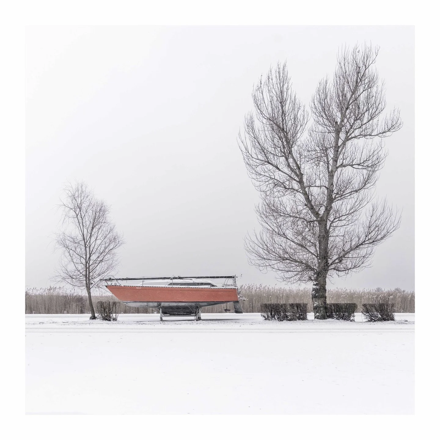 Grounded until spring thaw, this hull knows patience. The reeds whisper of warmer days, bare branches sketch stories into grey skies, and winter teaches every sailor to long for wind again.
📌 Neusiedlersee, Austria
✁&mdash;&mdash;&mdash;&mdash;&mdas