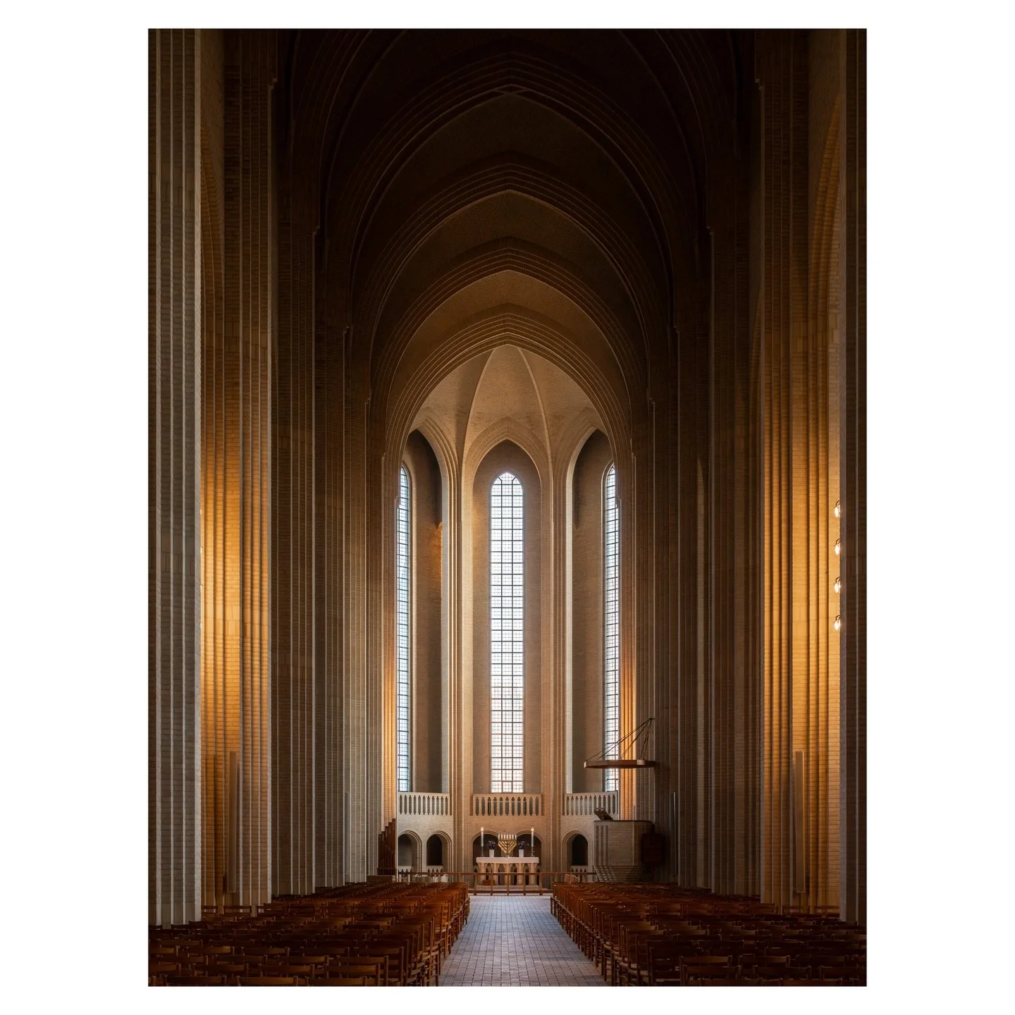 You enter through a modest door and suddenly the ceiling is unreachable, the walls stretch beyond logic, and every line converges toward the altar with mathematical certainty. Grundtvig&rsquo;s Church is the kind of place that recalibrates your sense
