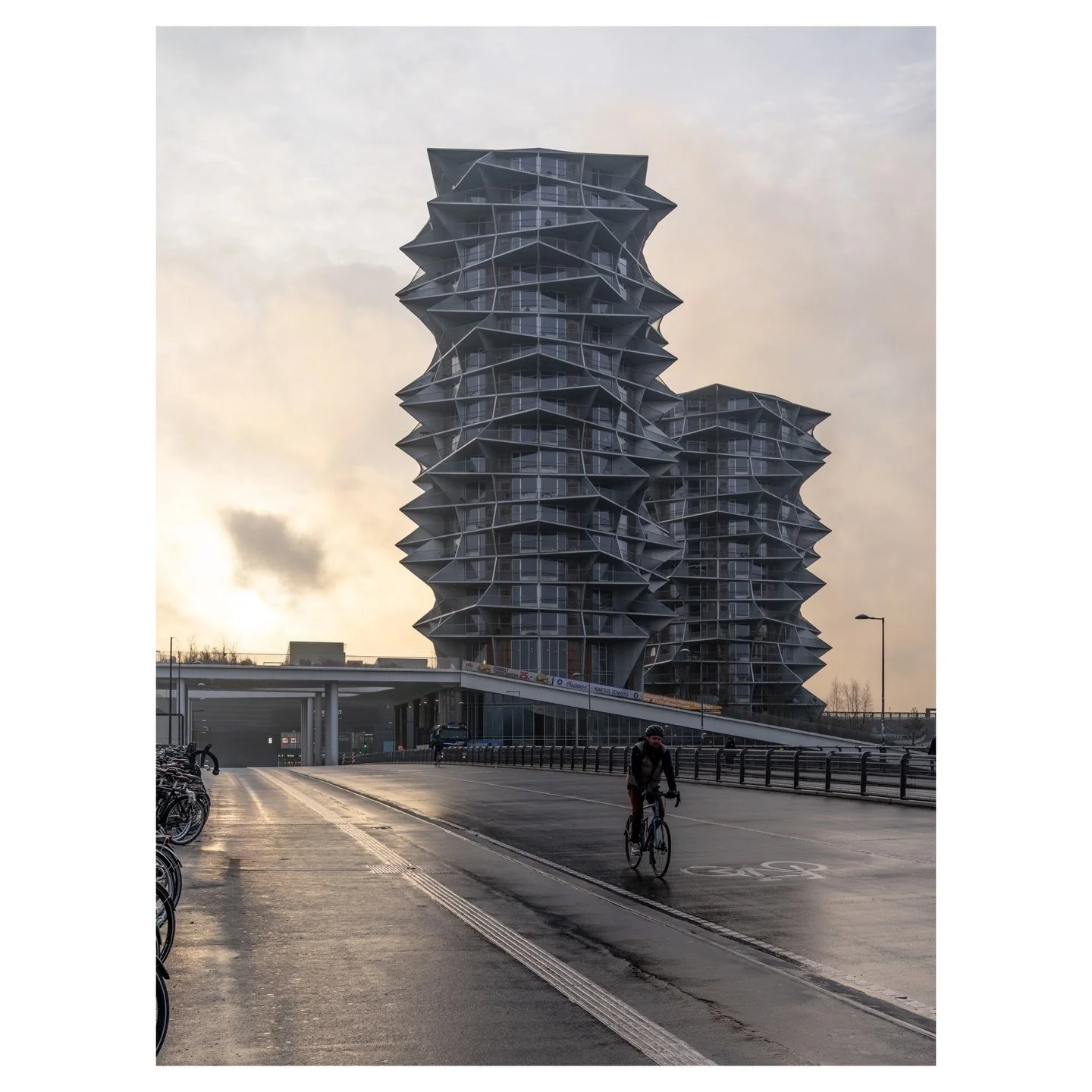A commuter pedals toward a building that bends like wind frozen in aluminium. &Oslash;restad is Copenhagen&rsquo;s architectural laboratory, and Kaktus Towers may be its boldest experiment yet.
📌 Copenhagen, Denmark
✁&mdash;&mdash;&mdash;&mdash;&mda