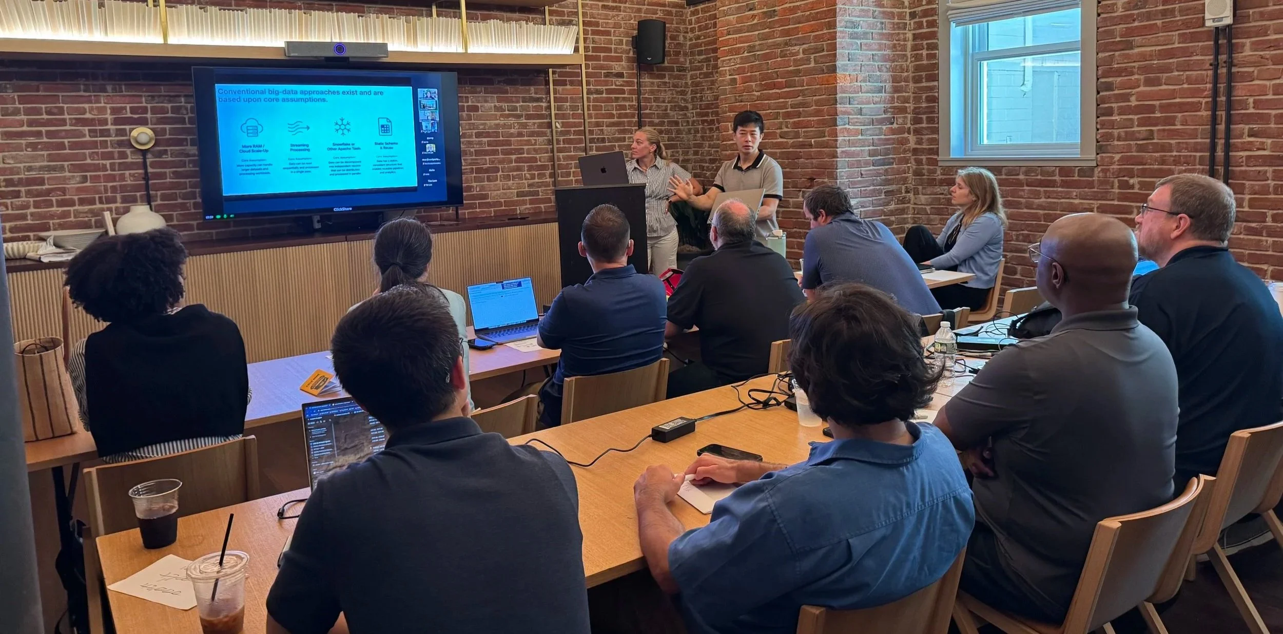 employees presenting new analytics dashboard at a company meeting