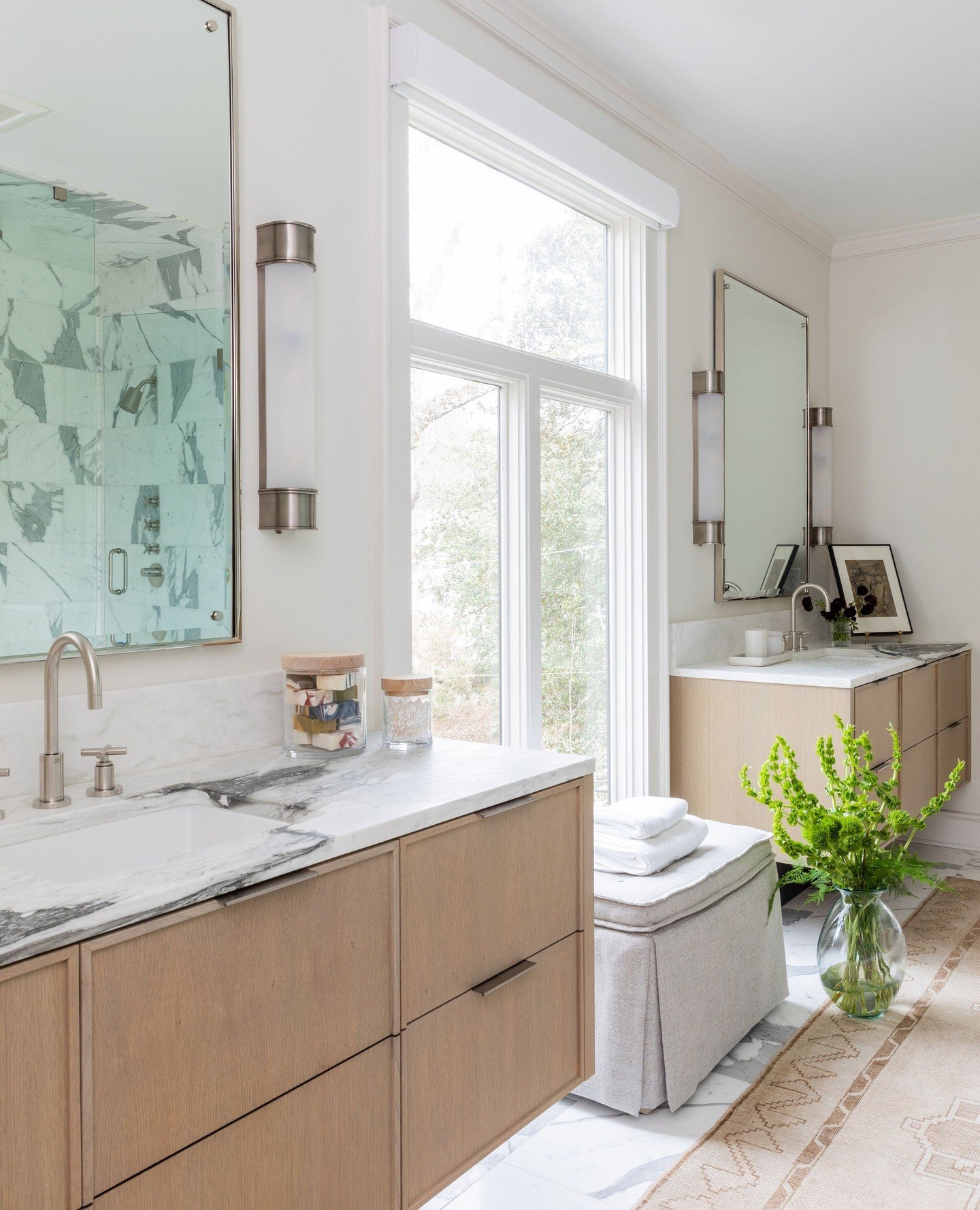 When we first stepped into this primary bathroom, it felt closed in and disconnected from the natural light just beyond the window. By removing the tub and slightly expanding the shower, we were able to open the space and create a layout that feels c