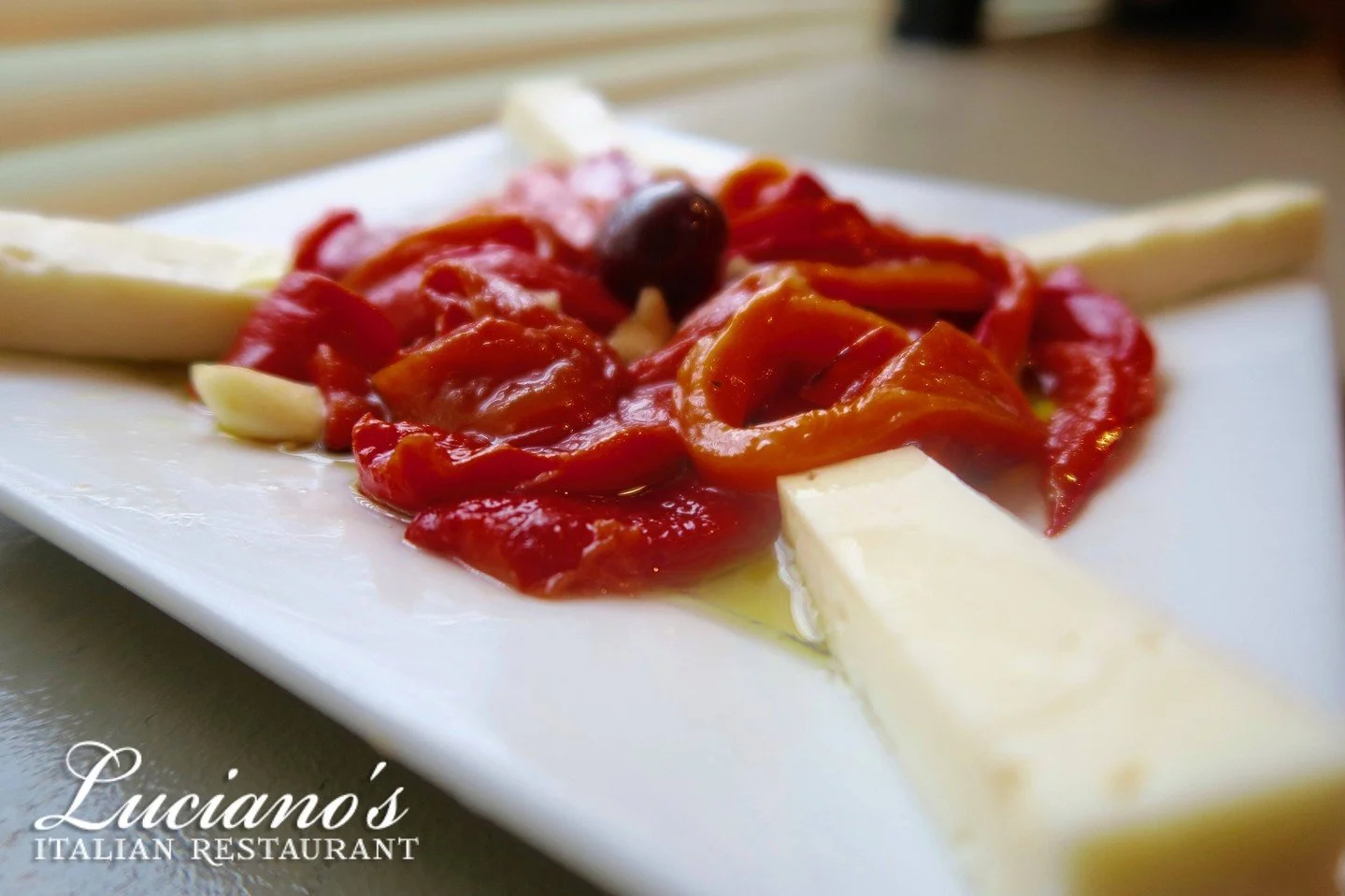 Roasted in house and marinated with fresh cut garlic and oil on top of creamy Fontinella Cheese.

Our Roasted Sweet Peppers are a must order!