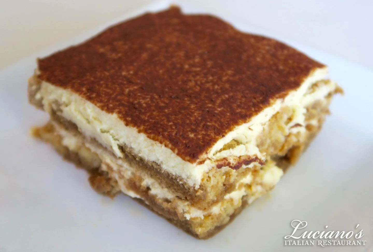 Indulge in Rosa's famous Tiramisu: espresso-soaked ladyfingers, creamy mascarpone, and a cocoa dusting&mdash;a true Italian delight!