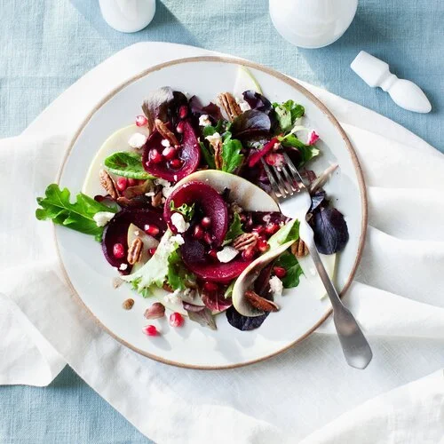 Beet and pear salad with pomegranates and walnuts