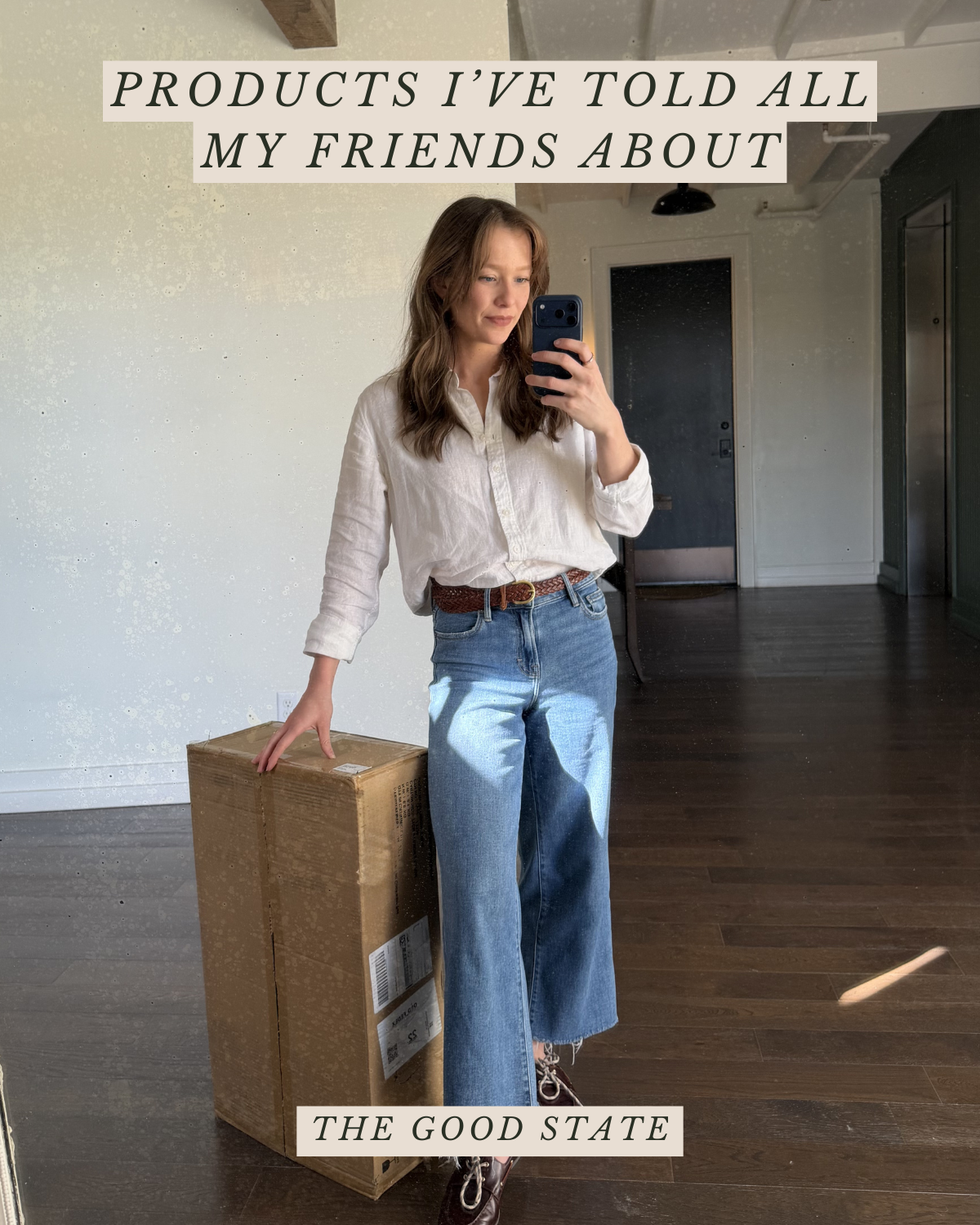 A woman taking a mirror selfie in a room, holding a cardboard box. She is wearing a white shirt, blue jeans, and brown boots, with a brown belt. The room has a dark wooden floor and a doorway in the background. Overlaid text reads: "PRODUCTS I’VE TOL