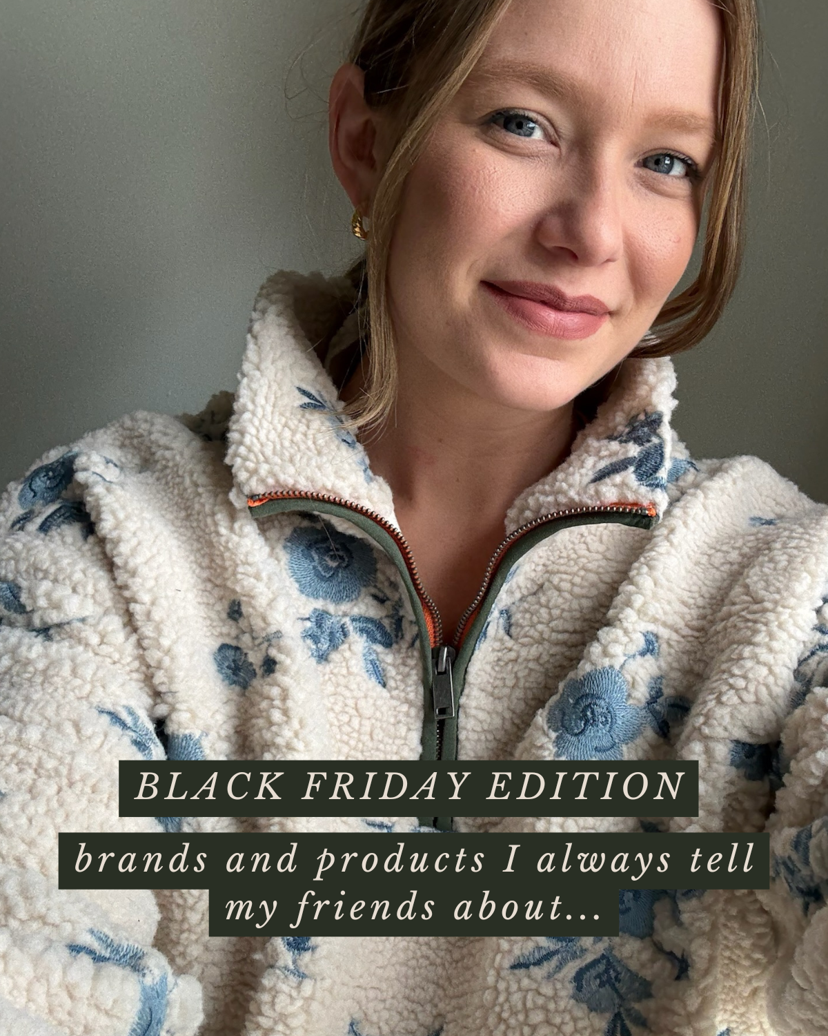 A woman with blonde hair and blue eyes taking a selfie, wearing a cream fleece jacket with blue floral patterns and a zipper, with text overlay about Black Friday edition and brands to tell friends about.