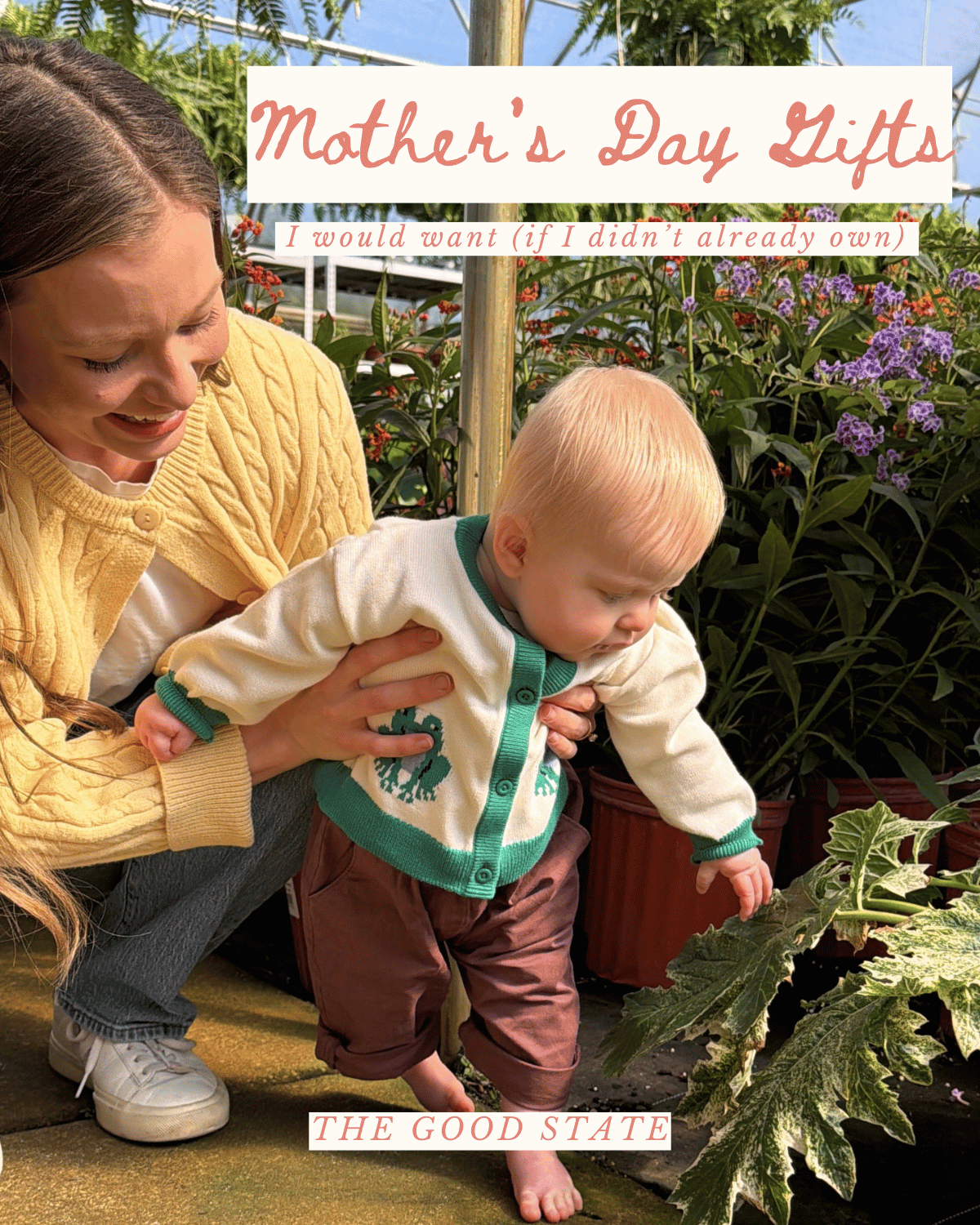 A young woman in a yellow sweater helps a toddler in a white and teal cardigan touch plants in a greenhouse with purple flowers and green foliage.