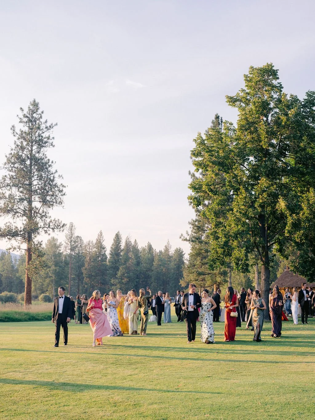 laurie-arons-special-events-montana-ranch-wedding-wedding-guests-walking-to-reception-golden-hour-montana-ranch.jpg