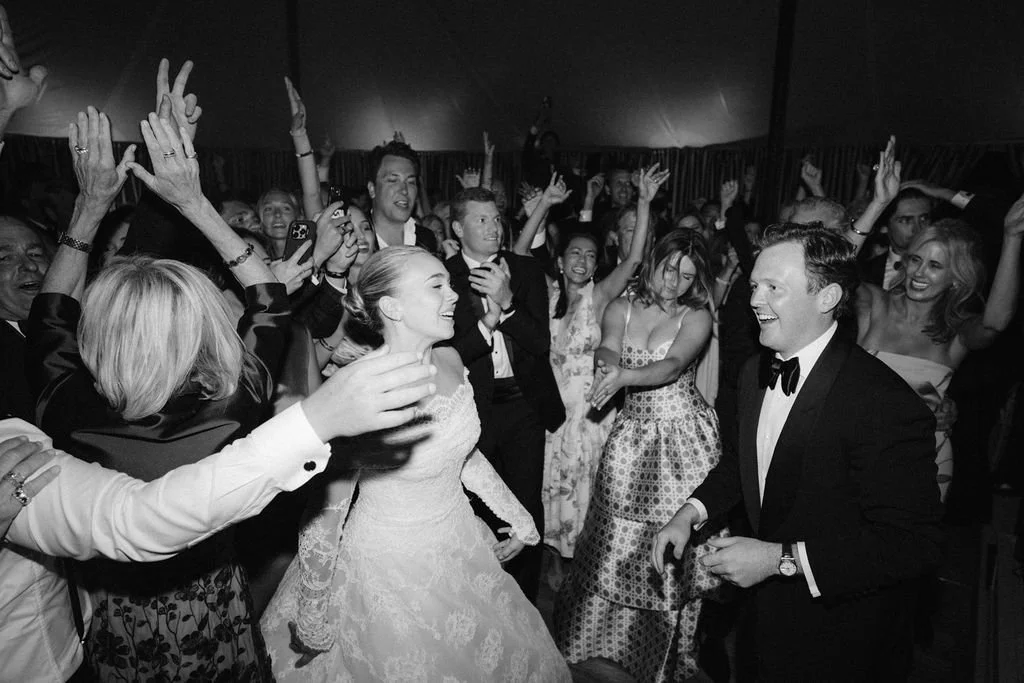 laurie-arons-special-events-montana-family-estate-wedding-bride-and-groom-dancing-with-guests-tented-wedding-celebration-black-and-white.jpg