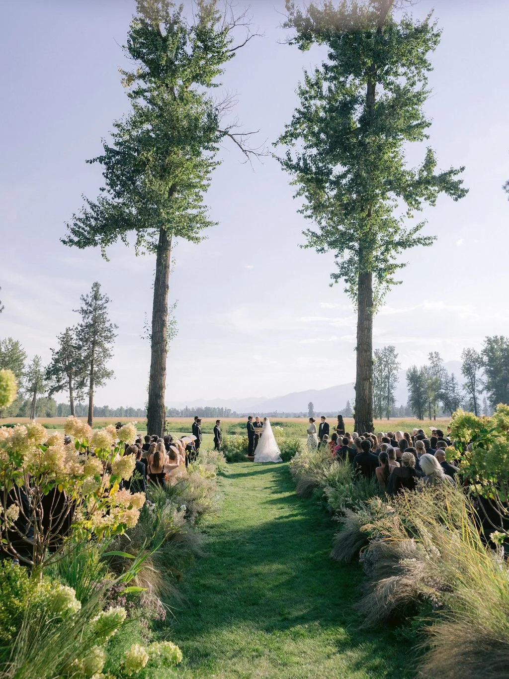 laurie-arons-special-events-montana-ranch-wedding-serene-ceremony-between-towering-cottonwoods-wildflower-aisle.jpg