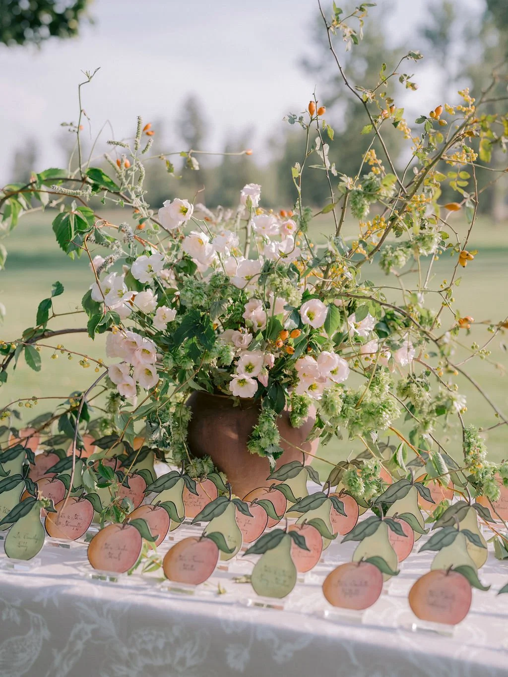 laurie-arons-special-events-montana-ranch-wedding-pear-and-peach-escort-cards-natural-wildflower-arrangement.jpg