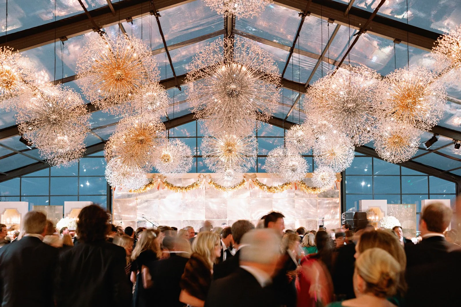 tented-wedding-reception-crowd-stage-garland.jpg
