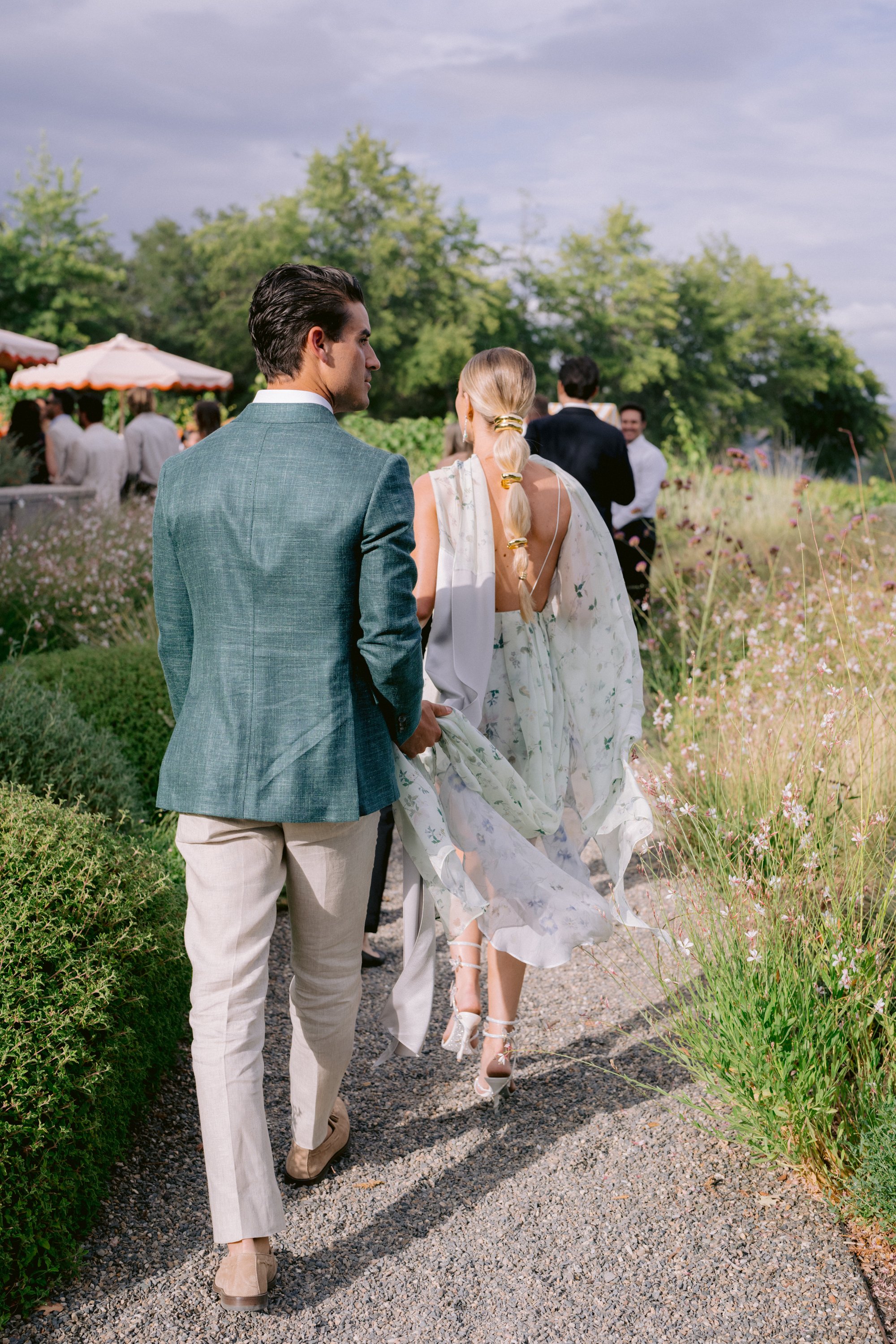 flowers-winery-california-wedding-couple-walking-vineyard_1.jpg
