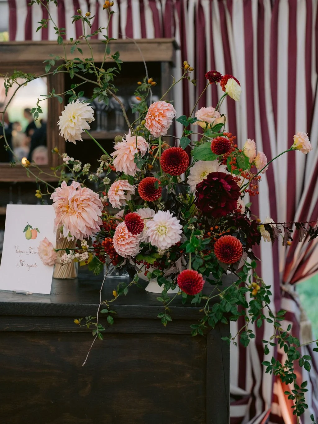 laurie-arons-special-events-montana-family-estate-wedding-dahlia-and-berry-floral-arrangement-signature-cocktail-bar-striped-tent-montana.jpg