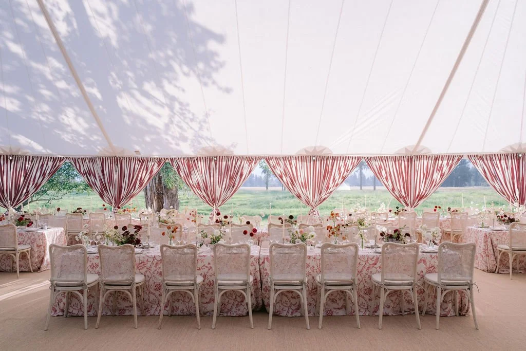 laurie-arons-special-events-montana-ranch-wedding-striped-tent-interior-layers-of-pattern-meadow-views-long-reception-tables.jpg