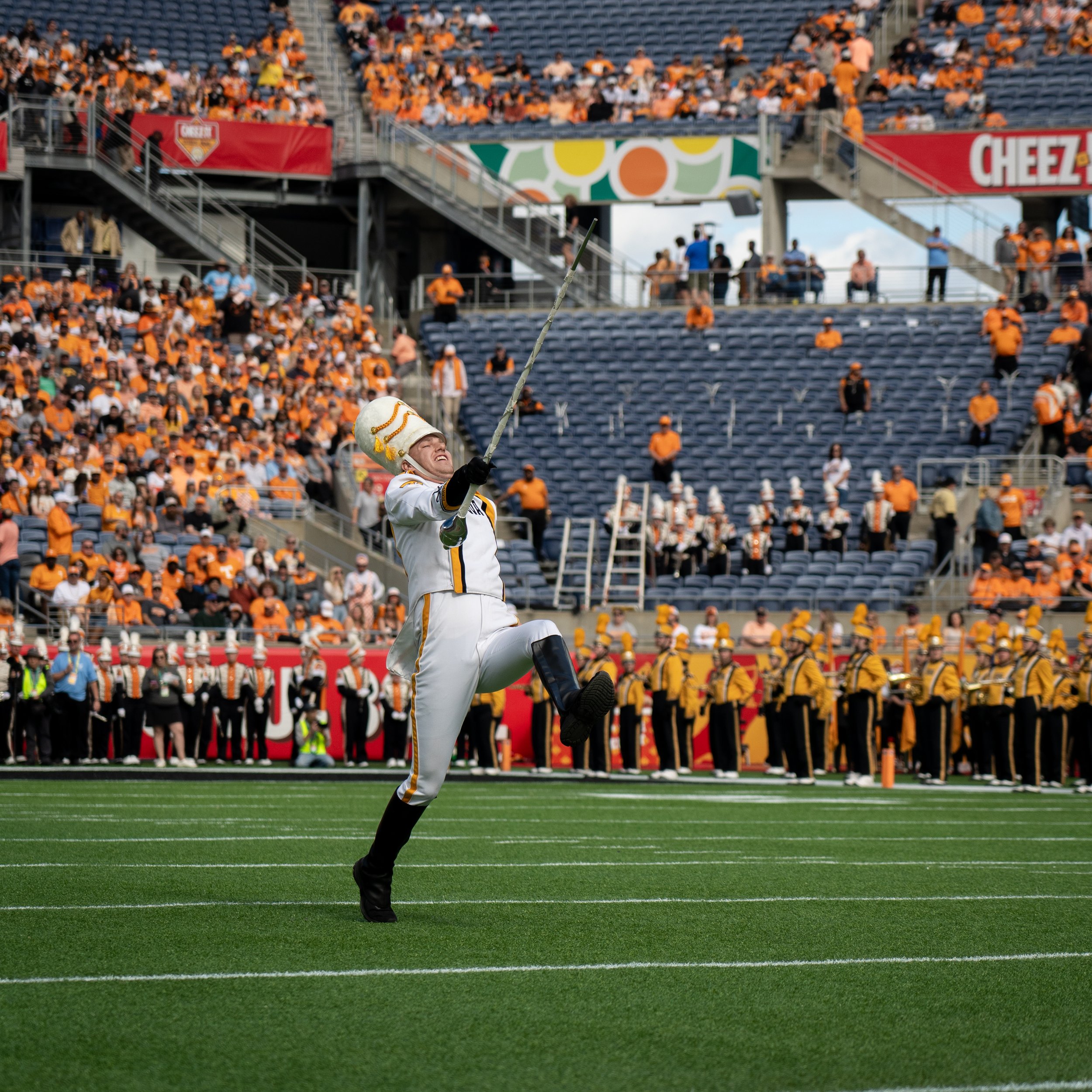 A PICTURE OF THE DRUM MAJOR OF THE HAWKEYE MARCHING BAND AS THEY TAKES THE FIELD AT THE CHEEZ-IT CITURS BOWL IN ORLANDO FLORIDA