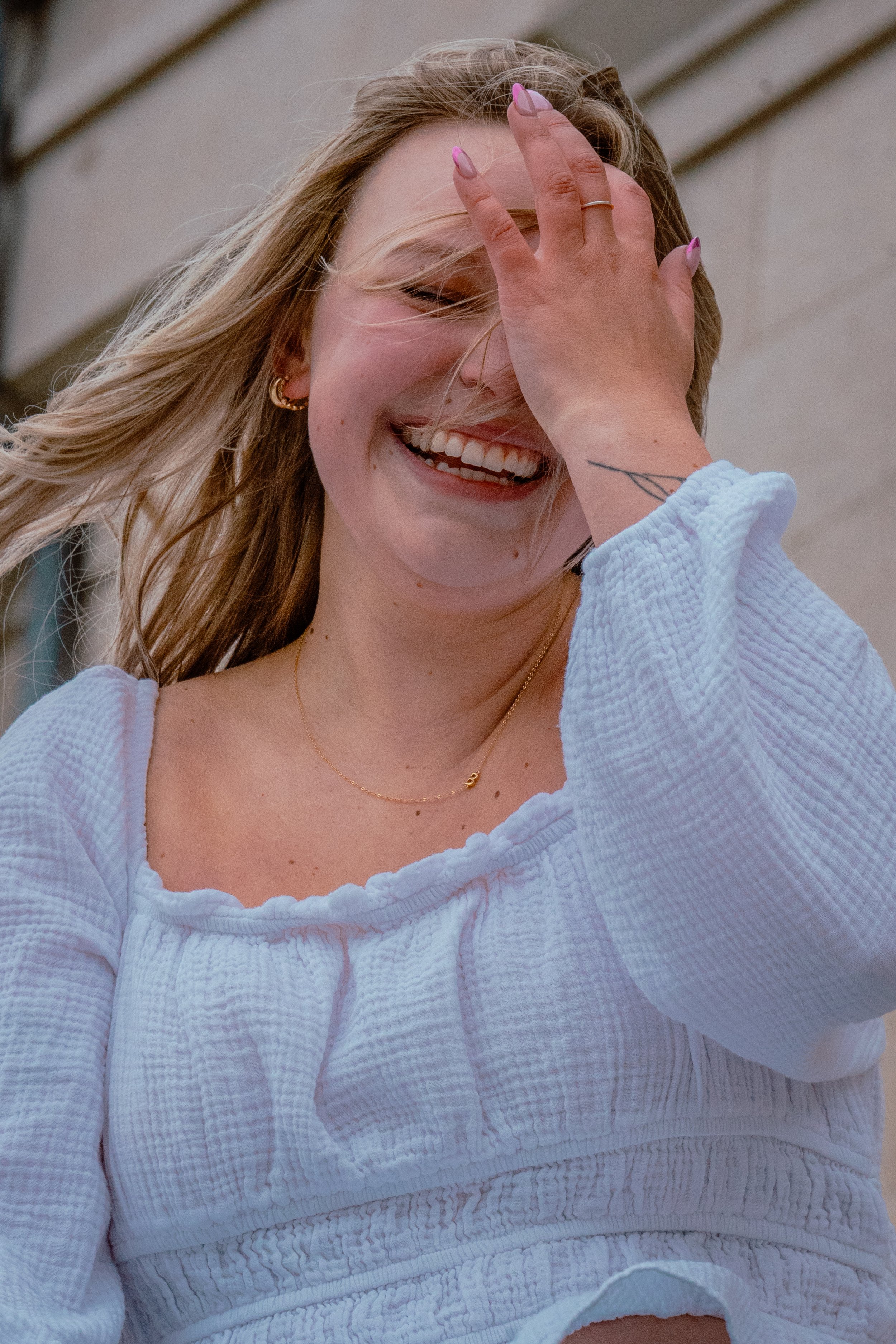 A WOMEN IN FROM OF THE OLD CAP IN IOWA CITY IOWA FOR GRADUATION PHOTOS