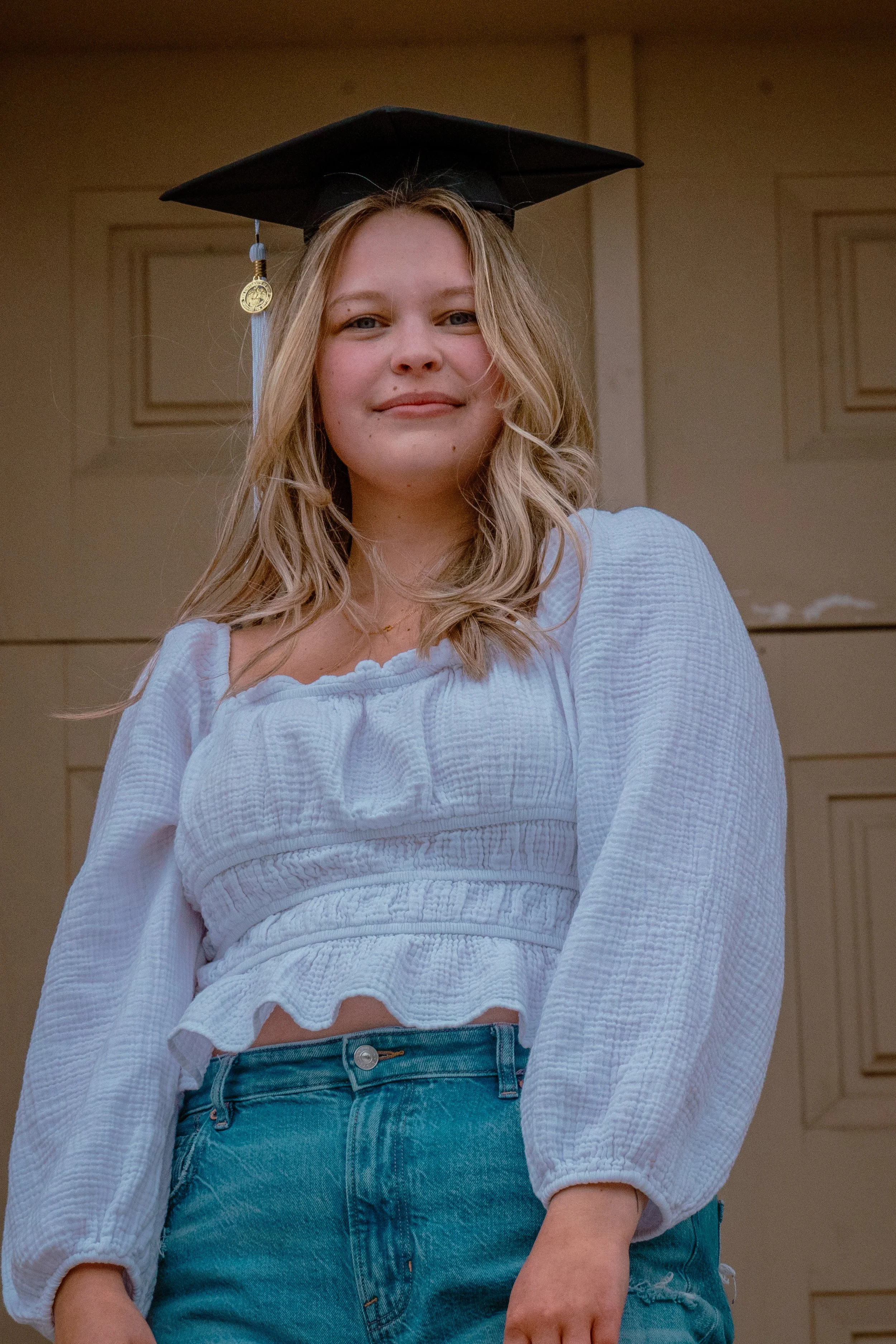 A WOMEN IN FROM OF THE OLD CAP IN IOWA CITY IOWA FOR GRADUATION PHOTOS