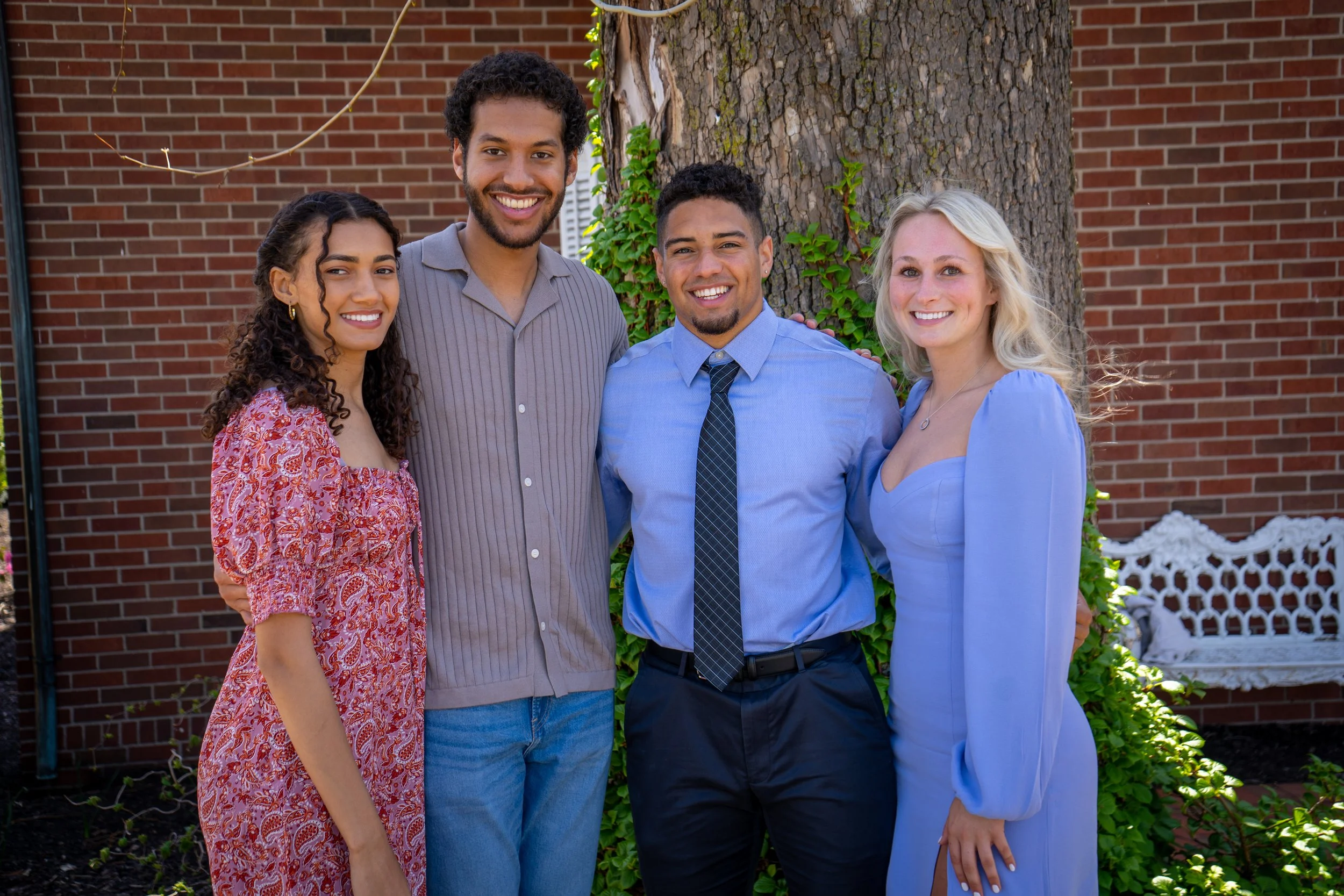 A GROUP OF FRIENDS AT A WEDDING TAKE A PICTURE TO REMEMBER THE MOMENT