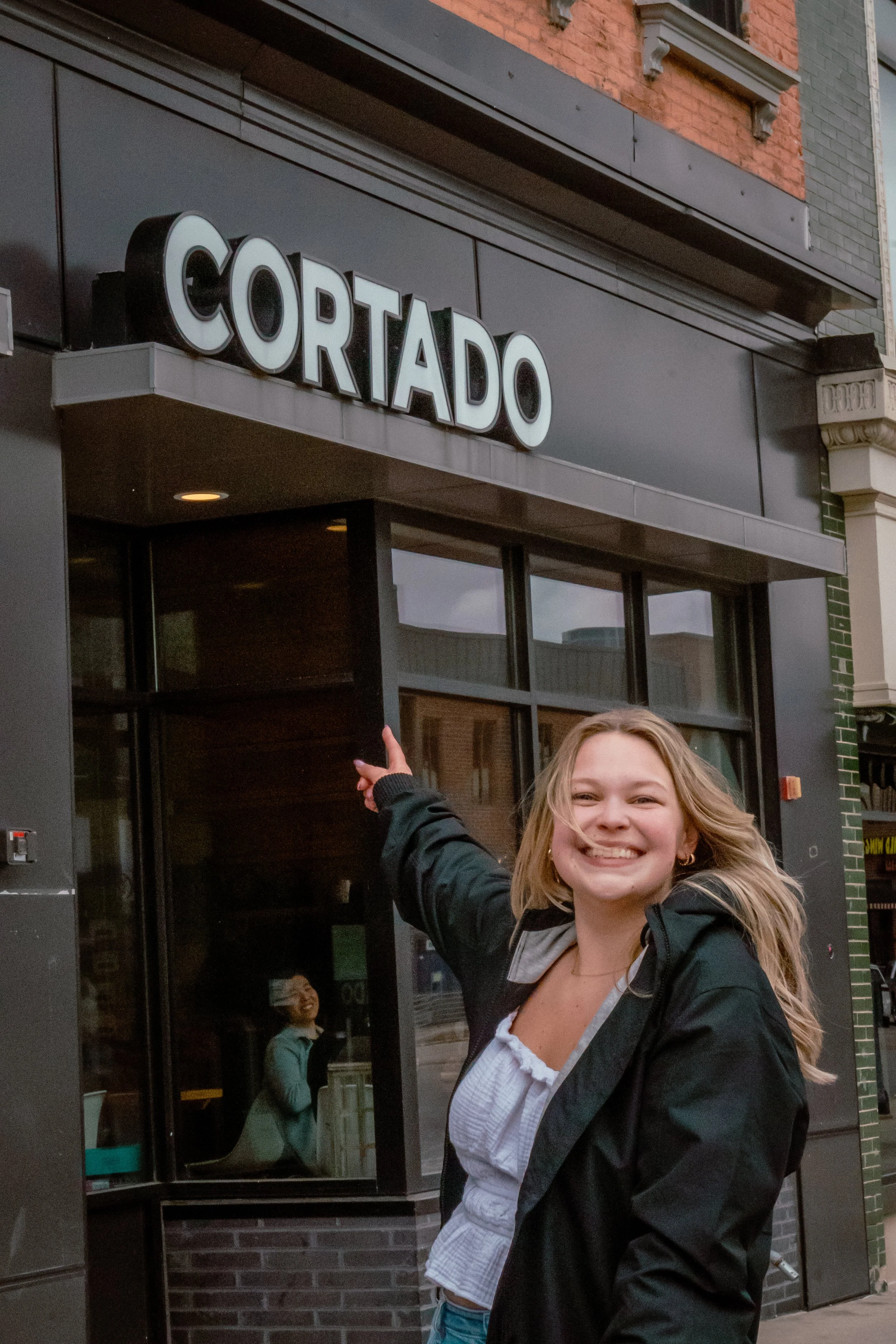 A WOMEN AT HER FAVORITE SPOT TO GET SOME FOOD ON CAMPUS "CORTADO"
