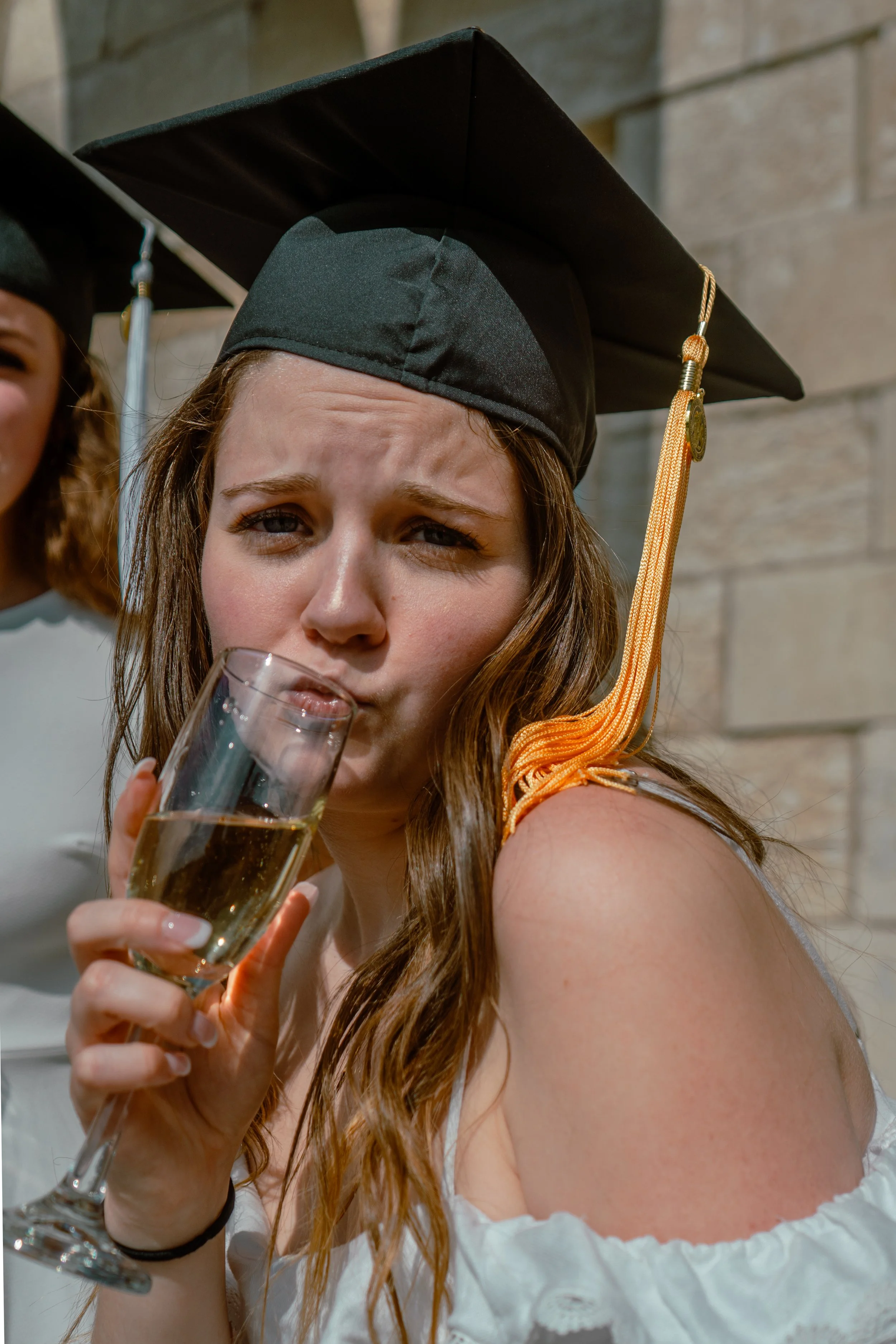 A WOMAN DRINKS CHAMPAGNE OUT OF A FLUTE