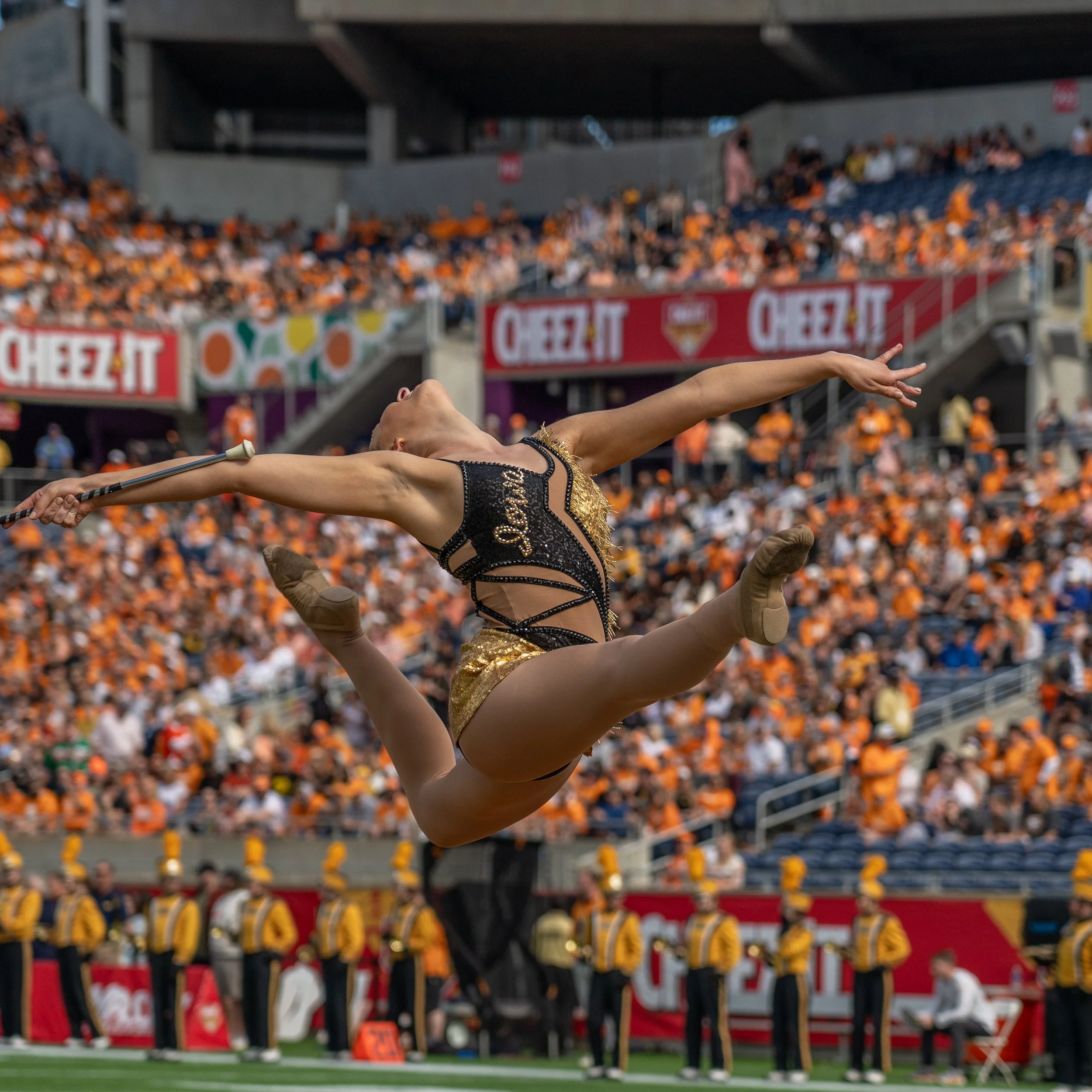A PICTURE OF THE GOLDEN GIRL OF THE HAWKEYE MARCHING BAND AS THEY TAKES THE FIELD AT THE CHEEZ-IT CITURS BOWL IN ORLANDO FLORIDA