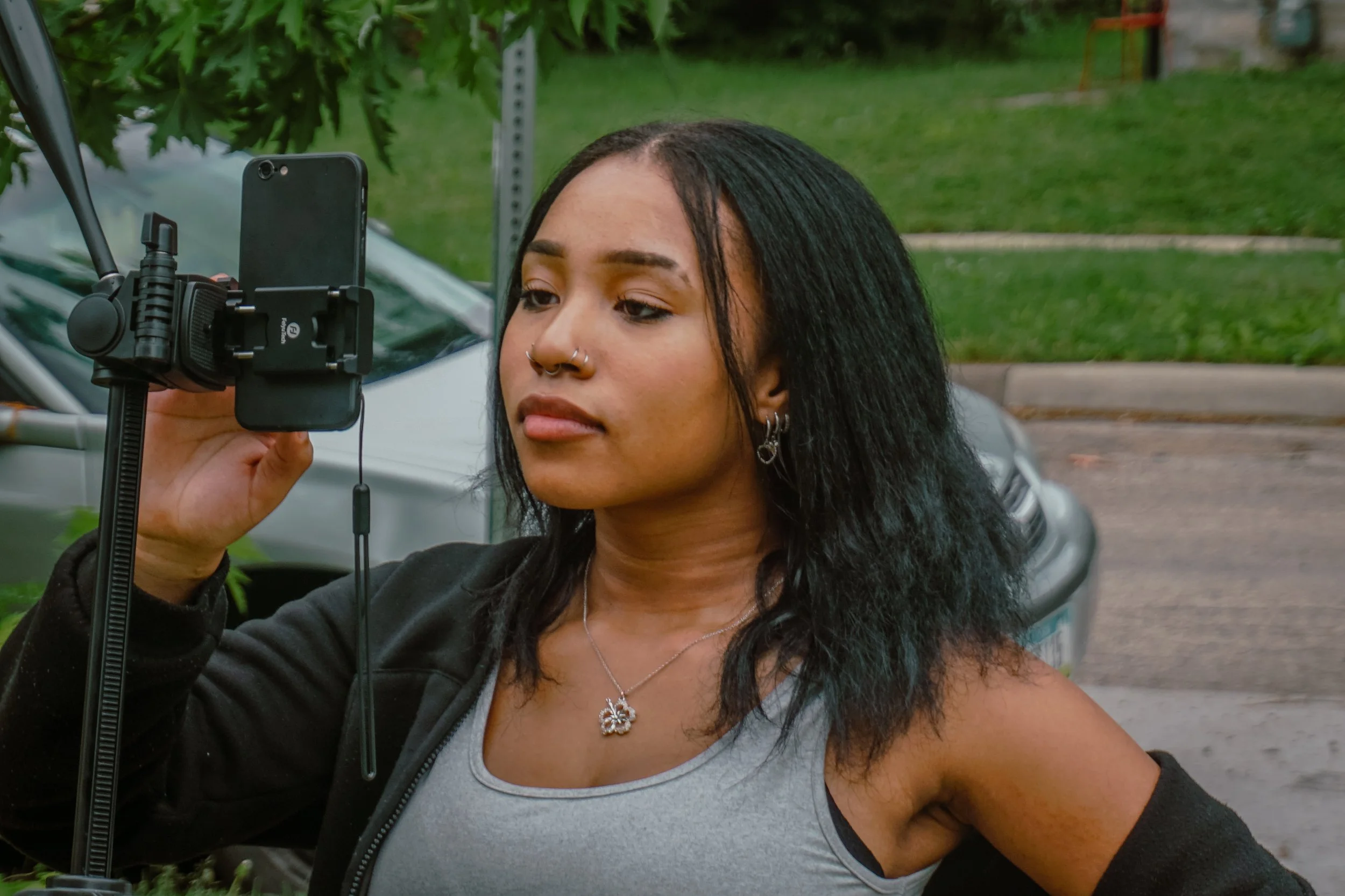 A UGC CONTENT CREATOR GETTING READY TO RECORD CONTENT IN THE MIDDLE OF A STREET