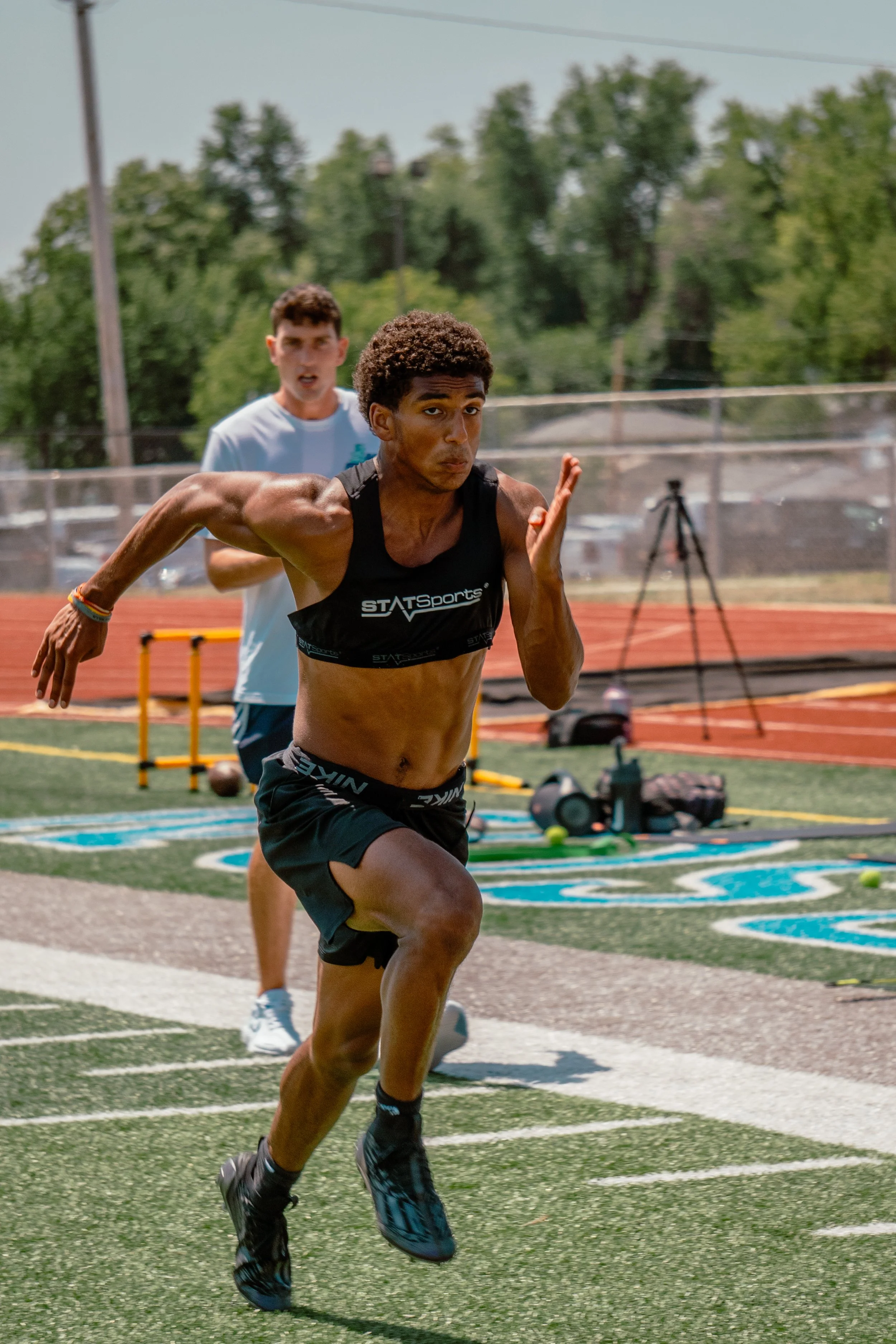 A MAN RUNING SUPER FAST THROUGH LAZERS TO TRACK HIS 40 METER TIME
