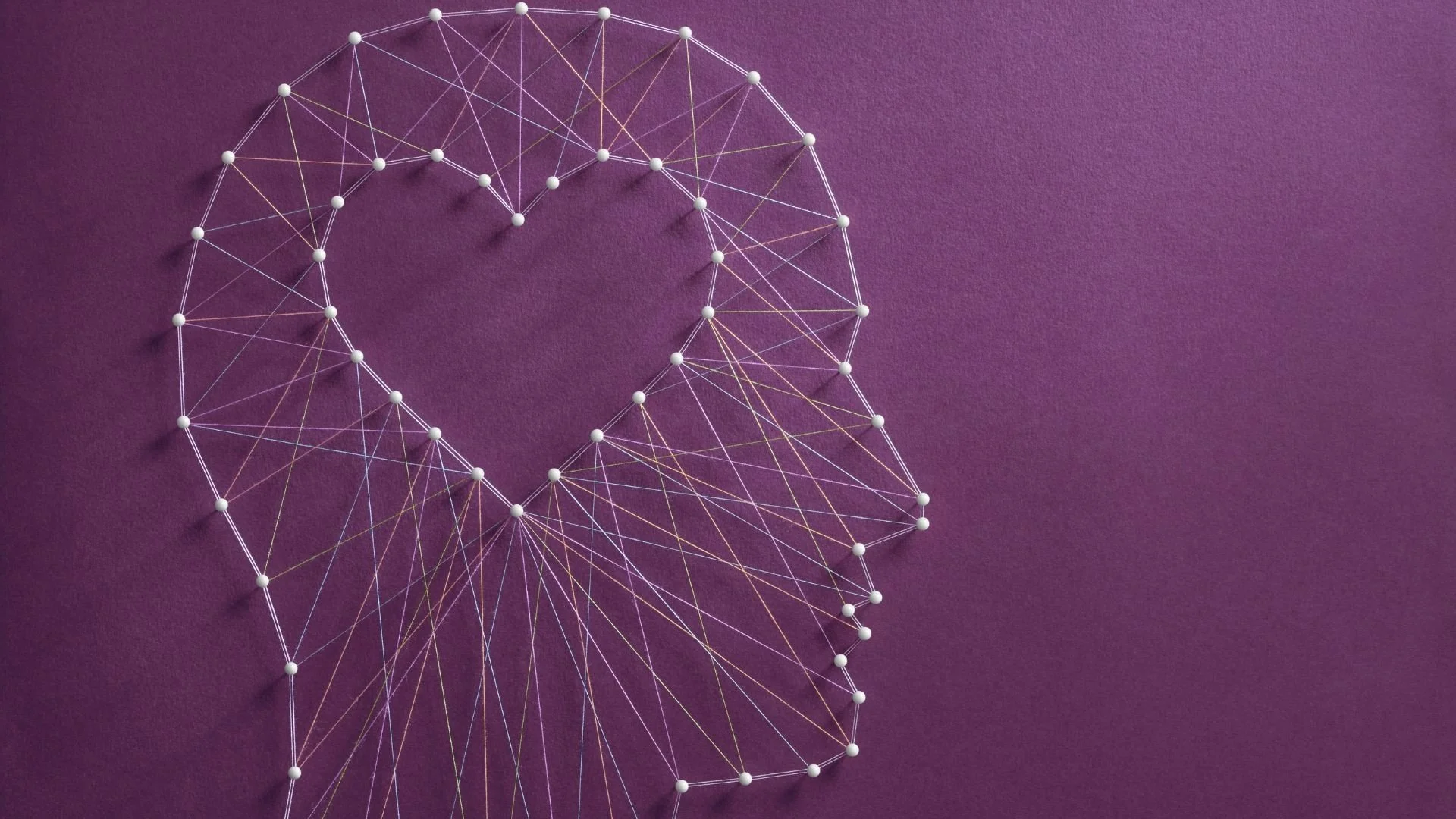 Abstract human head made of connected lines, representing relationship and money patterns.