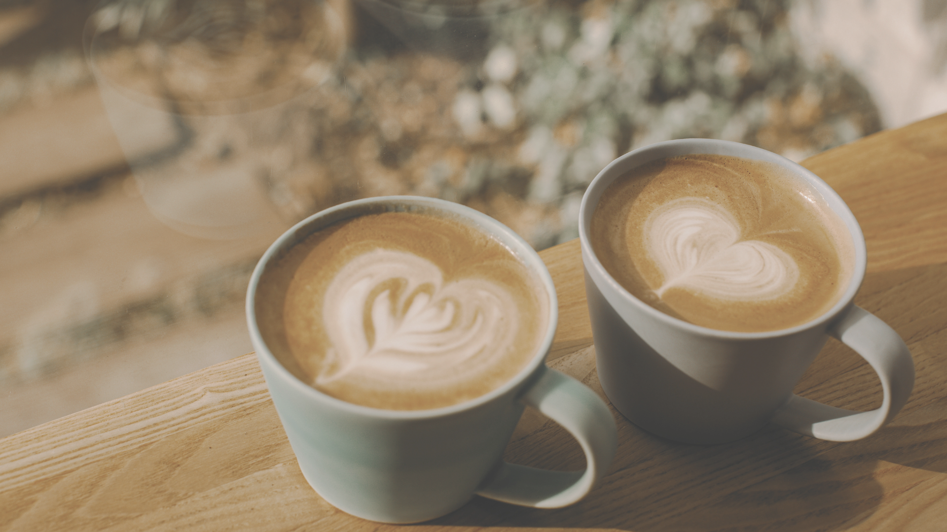 Two cups of coffee side by side with heart-shaped latte art, symbolizing connection, appreciation, and partnership in a relationship.