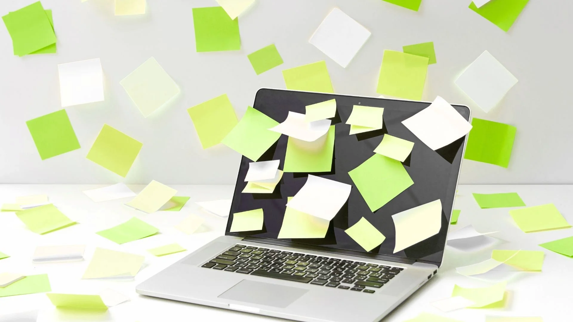 Laptop surrounded by colorful sticky notes representing unfinished financial tasks, mental clutter, open loops, and the hidden mental load many individuals and couples carry.