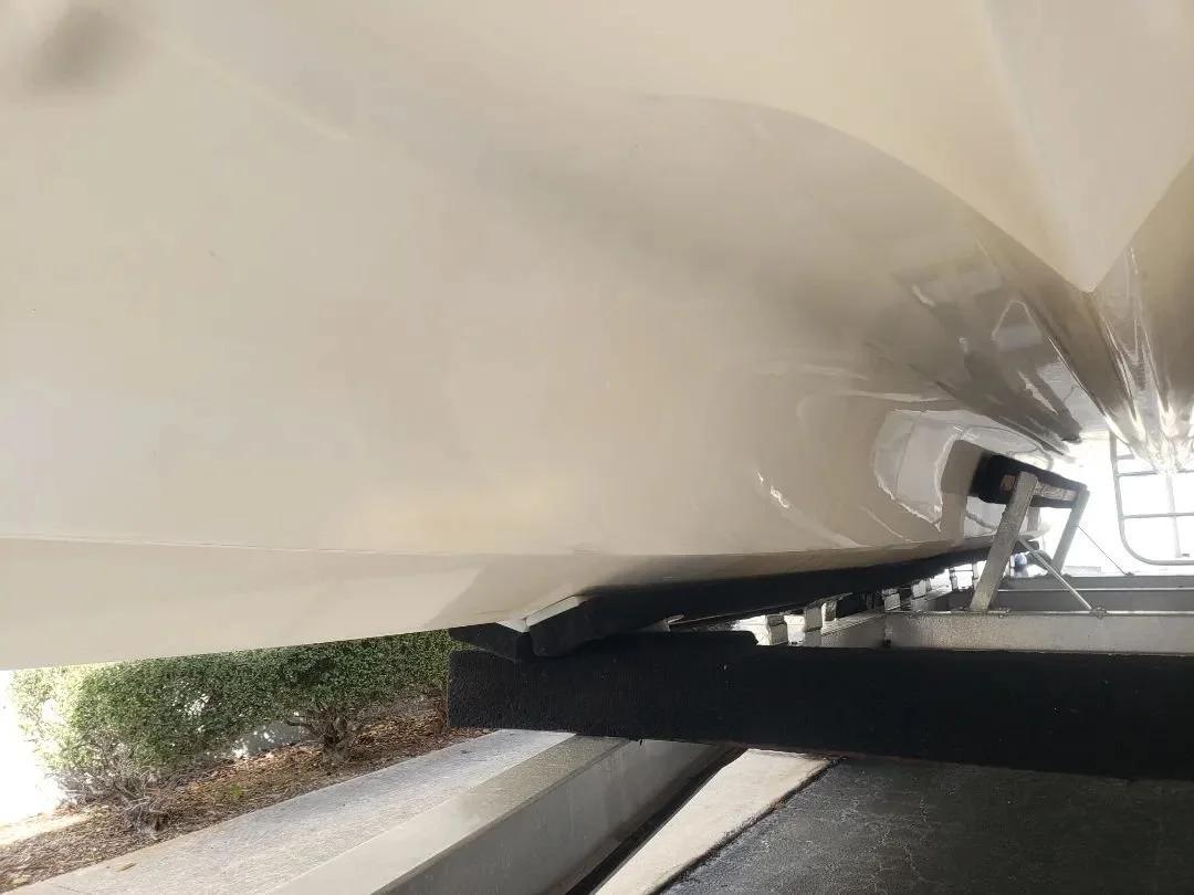 Removal of the orange stain and oxidation on the underside of the hull. Going to fix the gouges before he sells it.  Picture is before. Video is after.